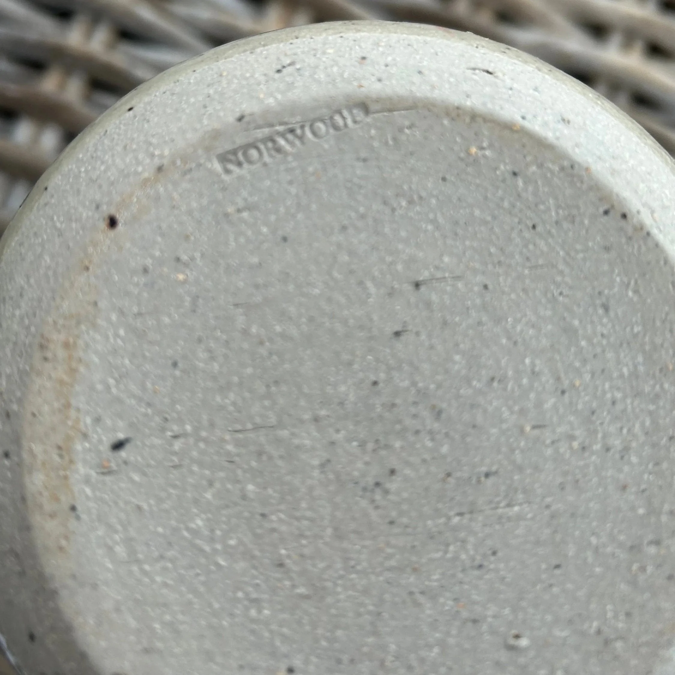 Close-up of maker’s mark “NORWOOD” on base of one canister