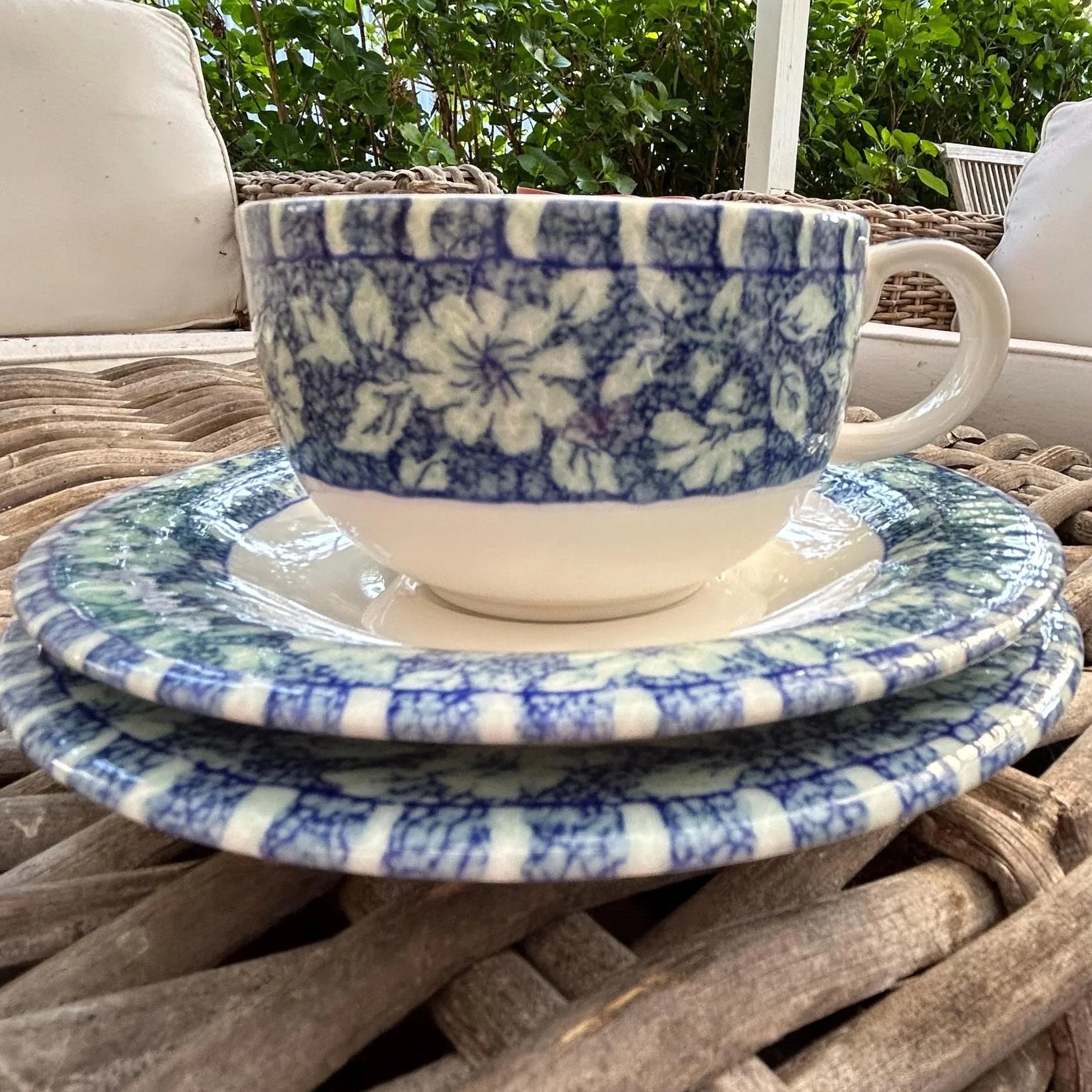 Stack of plates showing blue floral rim design and glossy finish