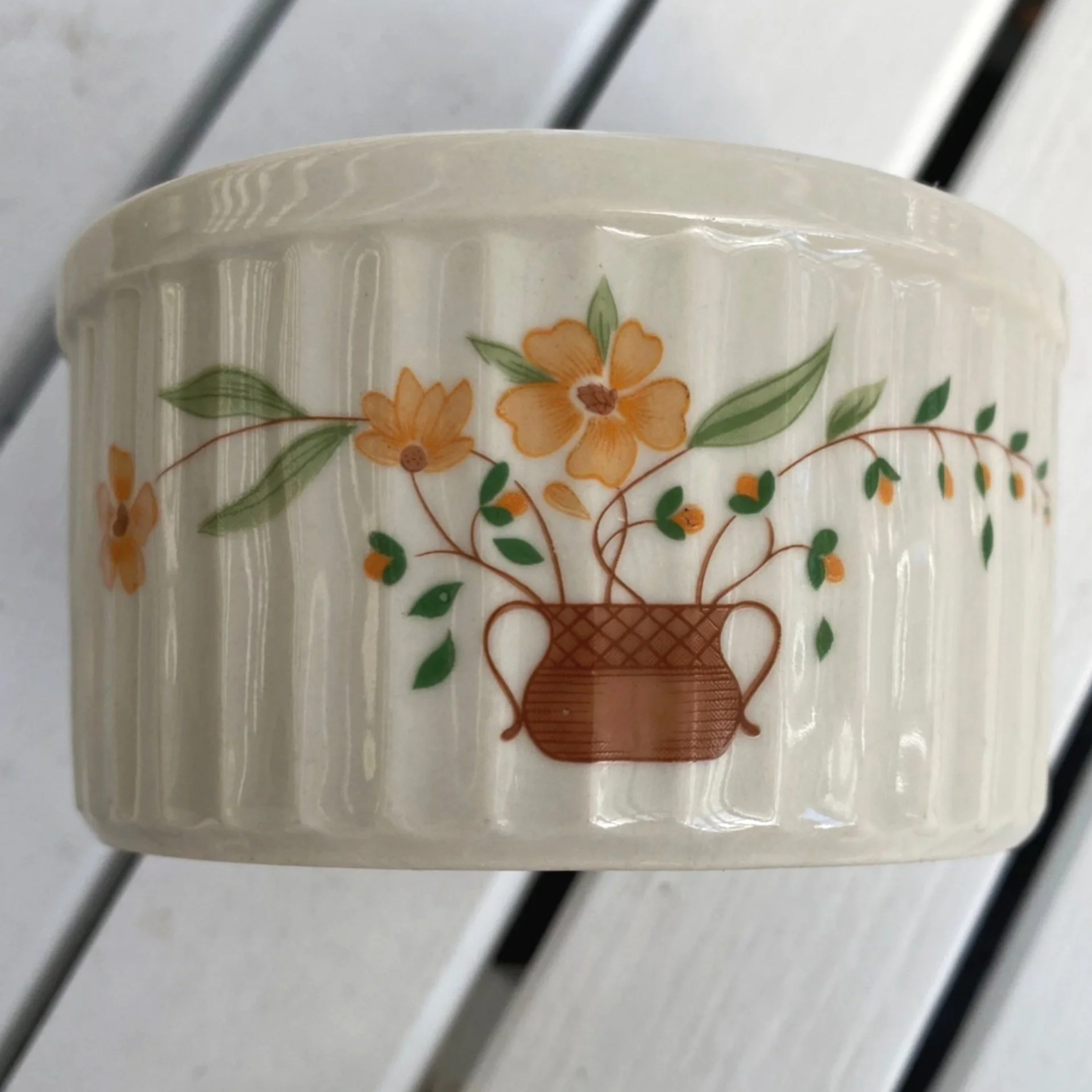 Front view of Countryside ramekin with floral basket design and ribbed sides