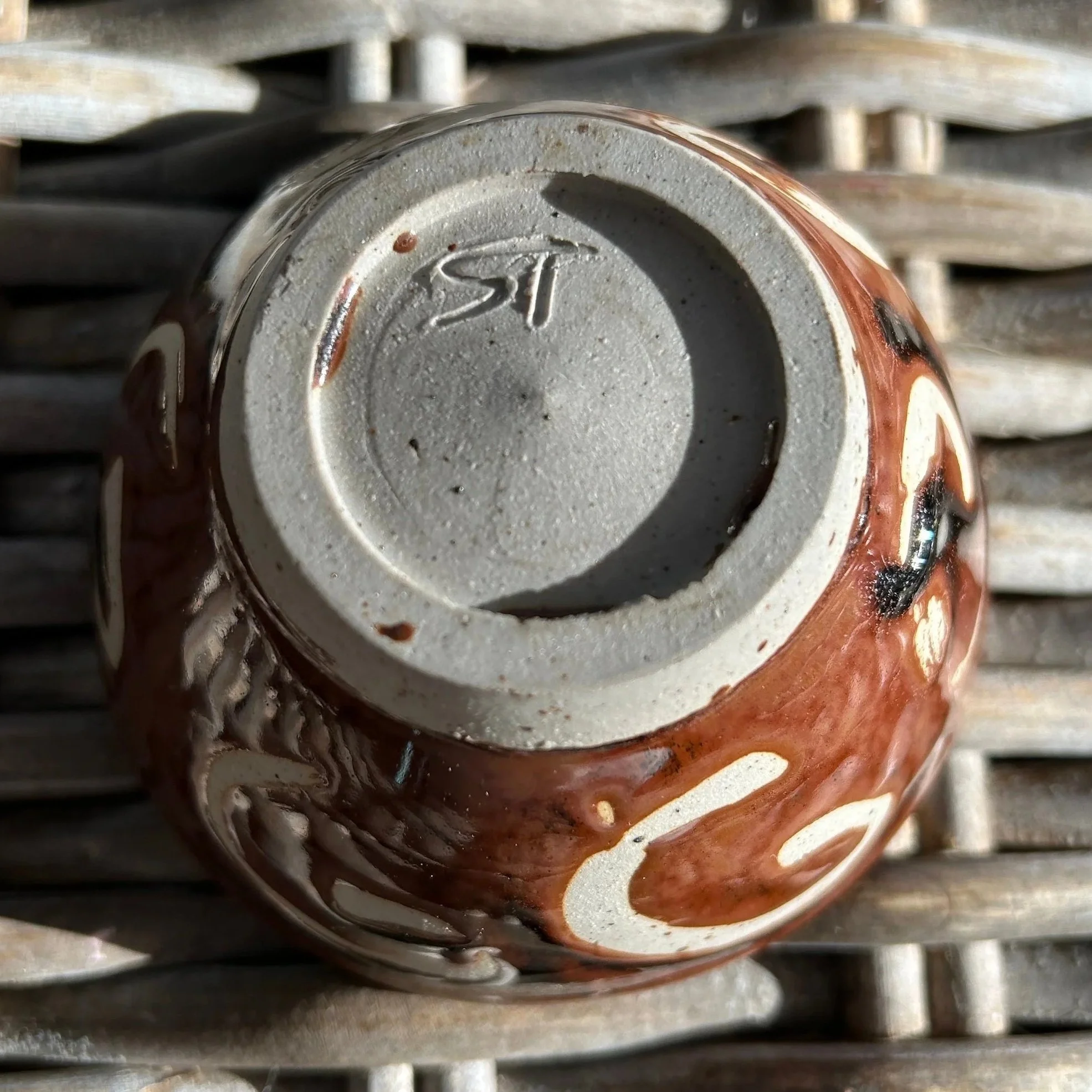 Base of bowl with visible “ST” artist signature