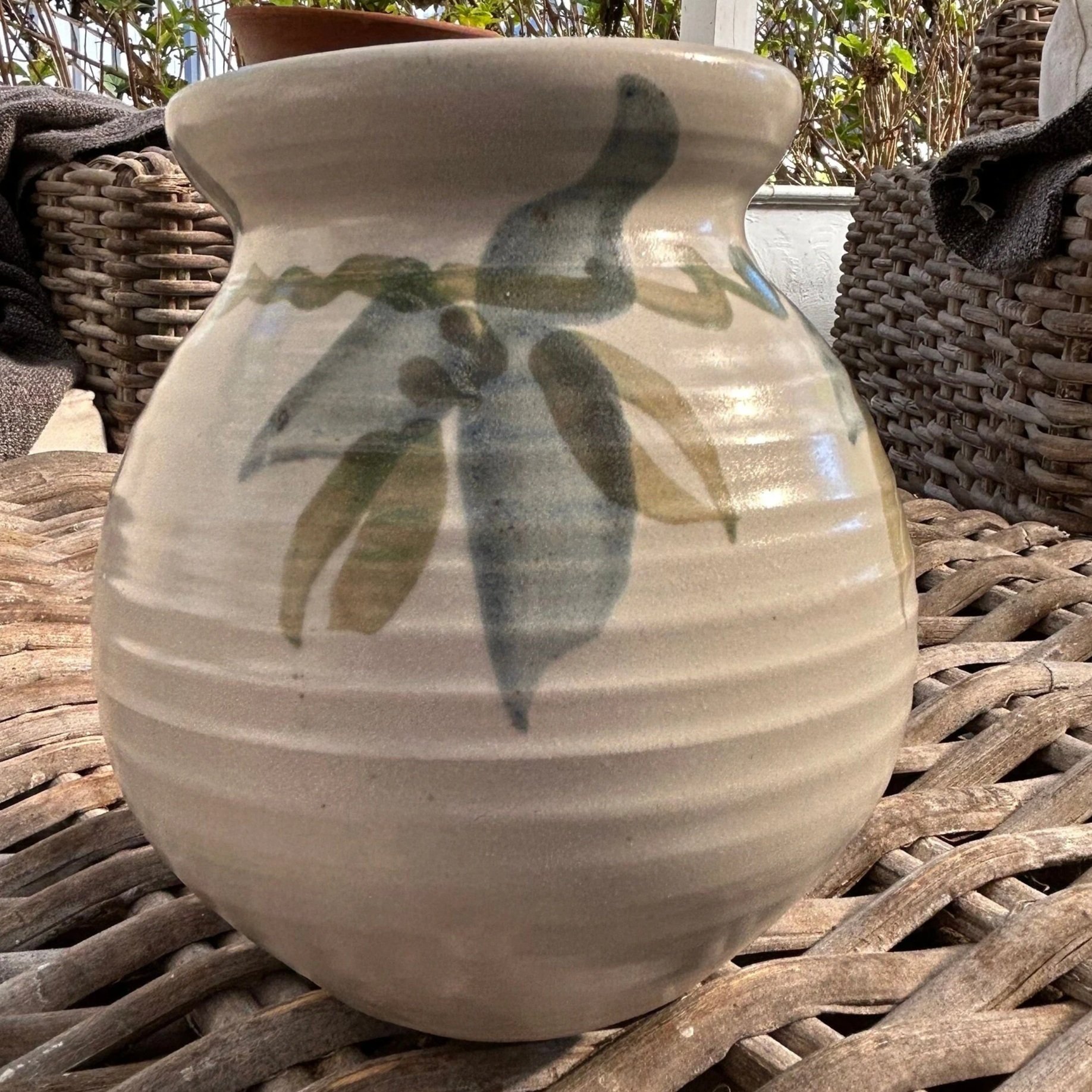 Full vase profile highlighting painted leaf design and curved shape