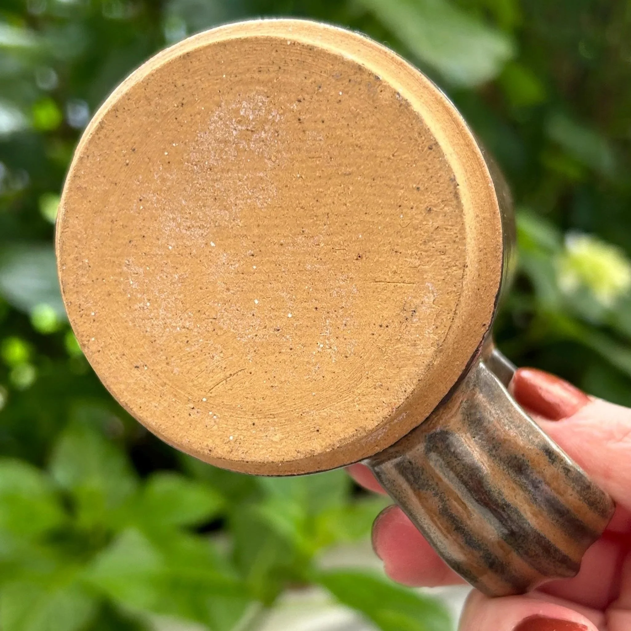 Unglazed base showing natural clay tone and circular ridges