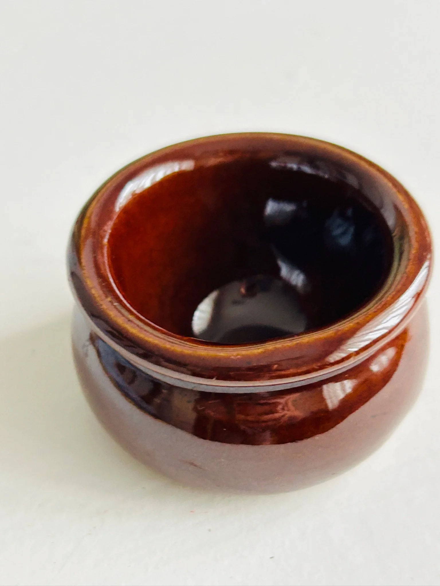 Top view of the brown glazed salt cellar showing the rounded interior and flared rim