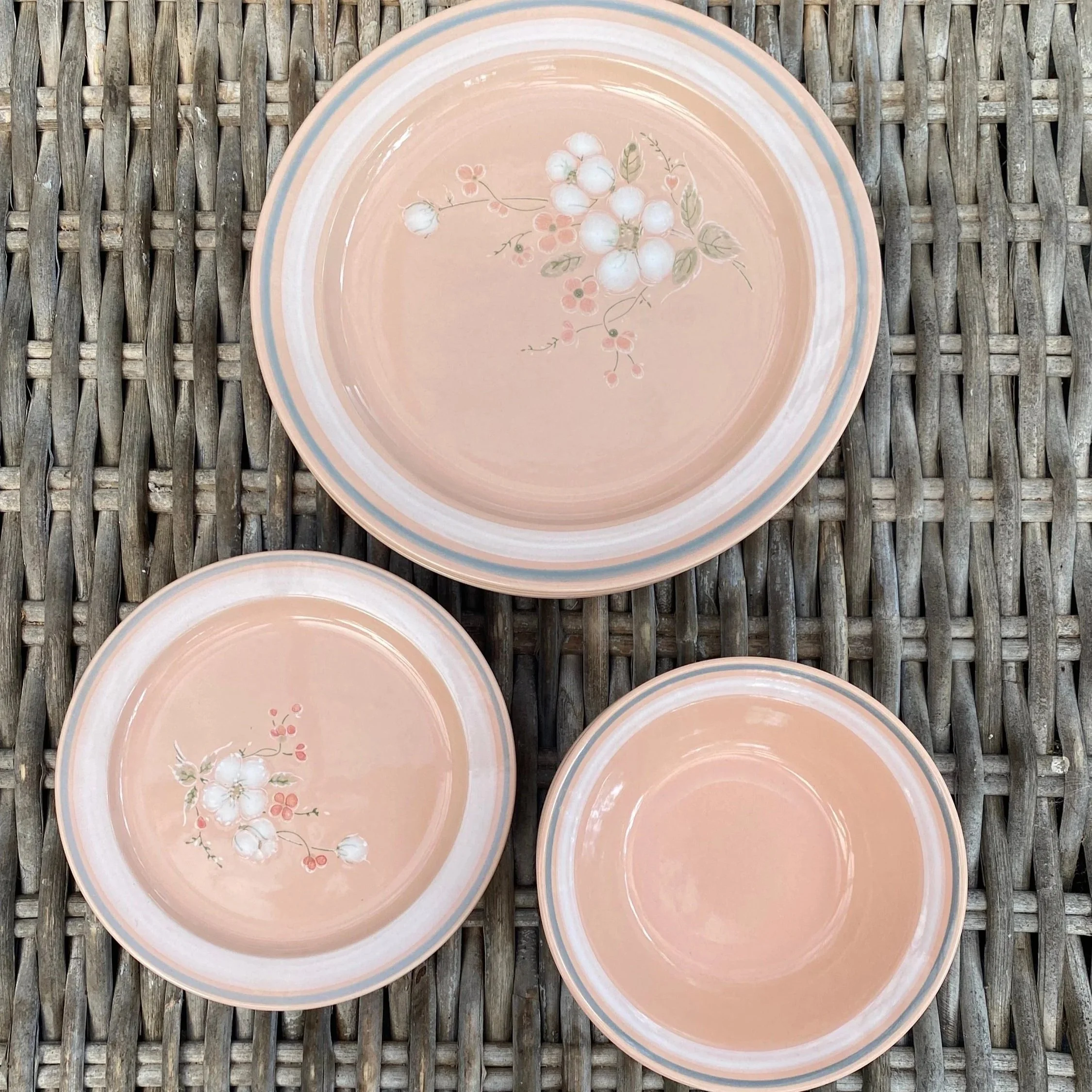 Essentials peach stoneware dinner plate and bowls showing floral pattern