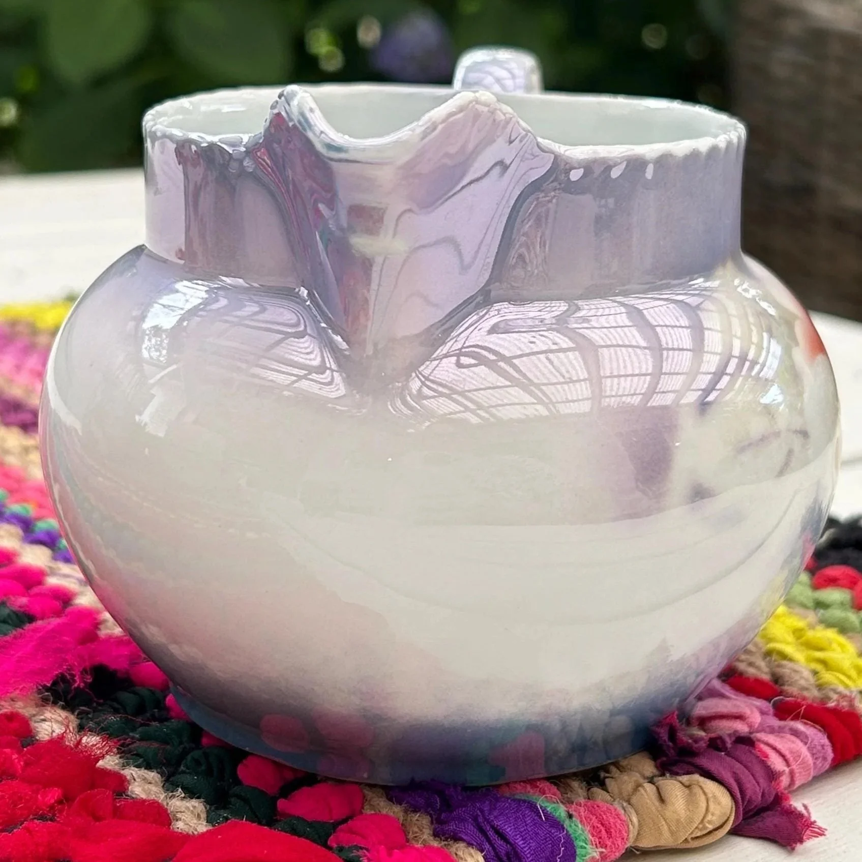 Rear view of creamer showing ruffled top rim and ombré glaze