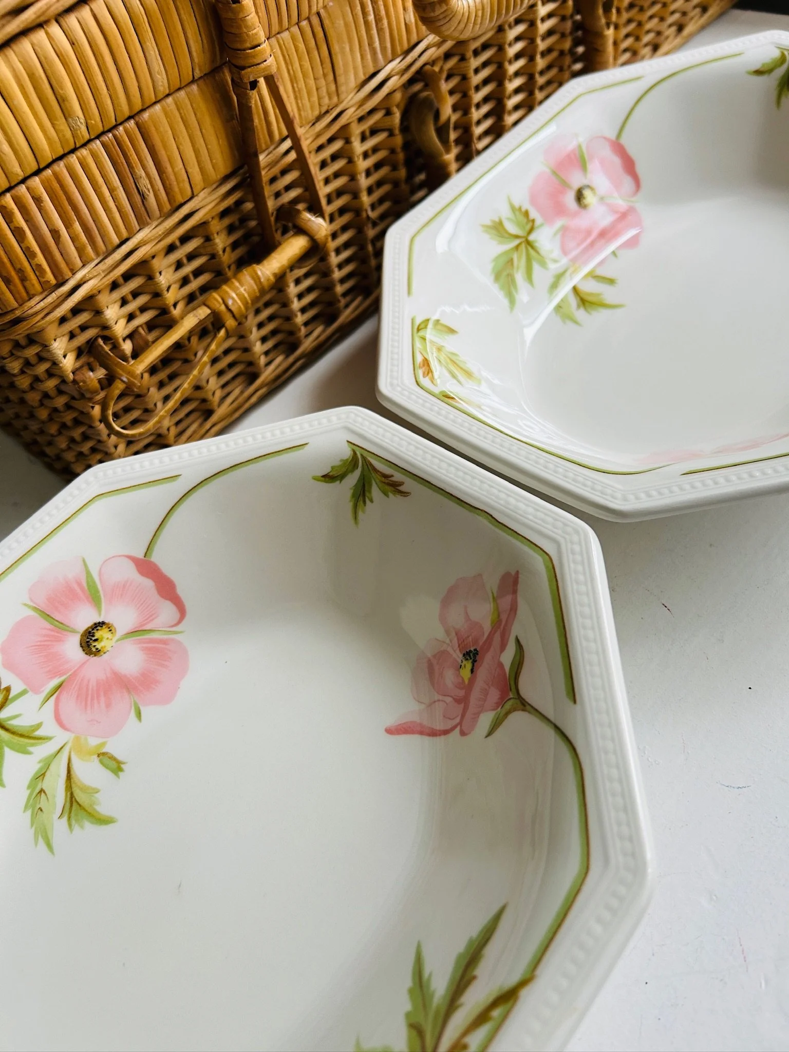 Pair of octagonal floral bowls displayed on a white surface, showing the full set from above.