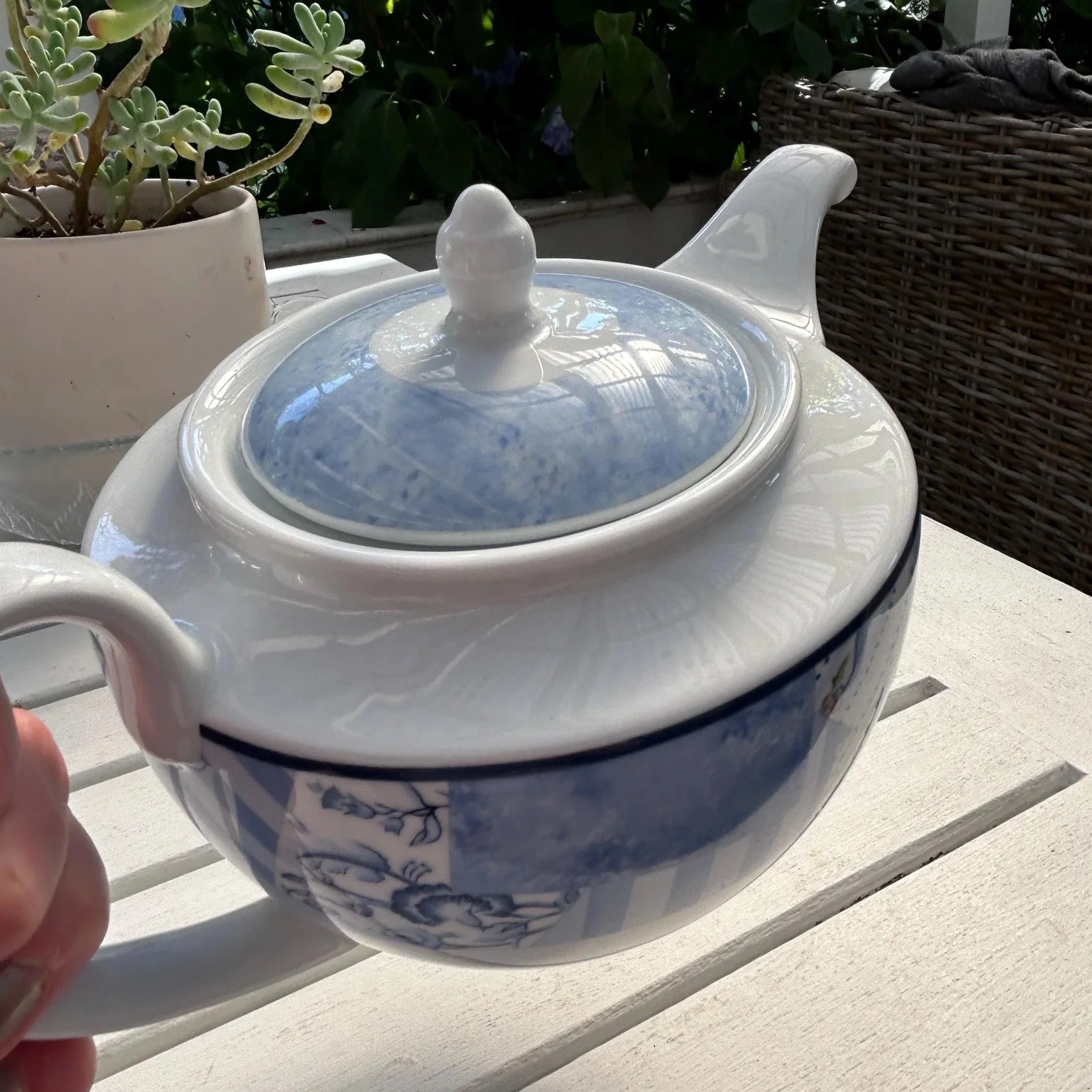 Angled top view of the teapot with lid in place, showing the rounded body and spout