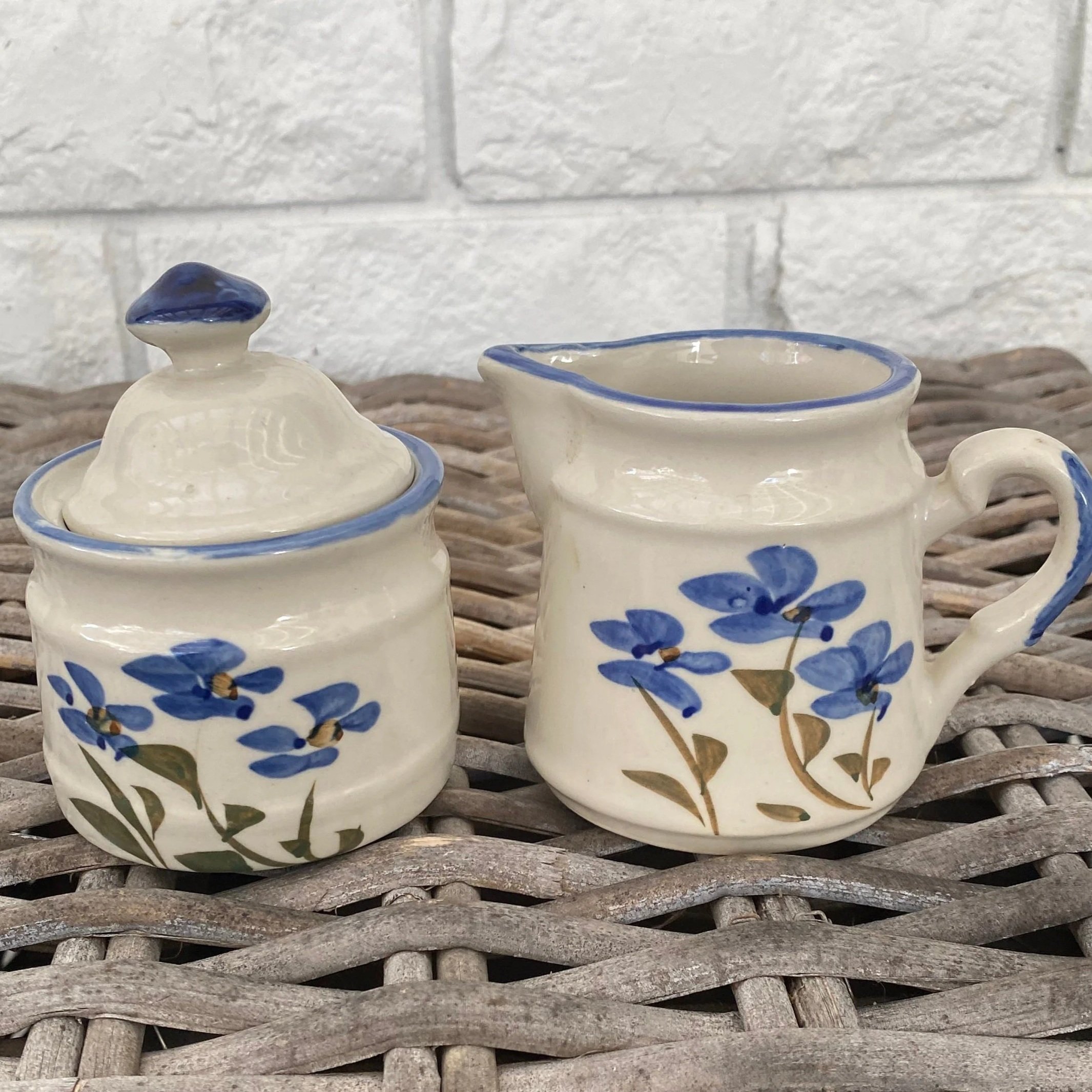 Full view of sugar bowl and creamer with matching floral pattern