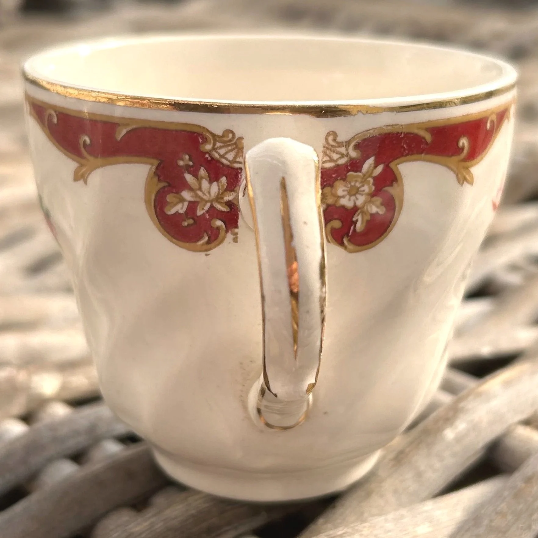 Rear view of teacup showing full handle and decorative gold trim