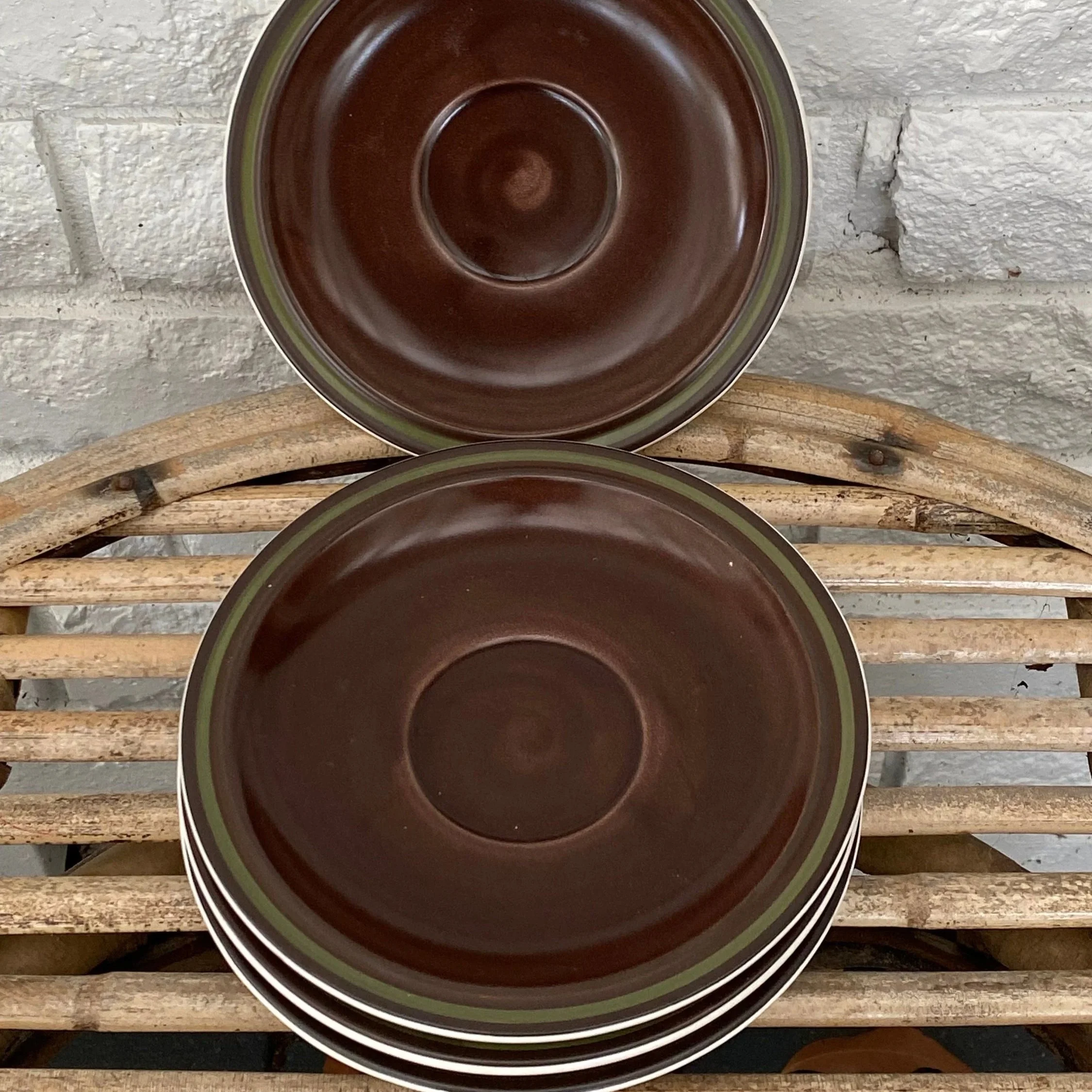 Two saucers propped up to display colour depth and rounded form