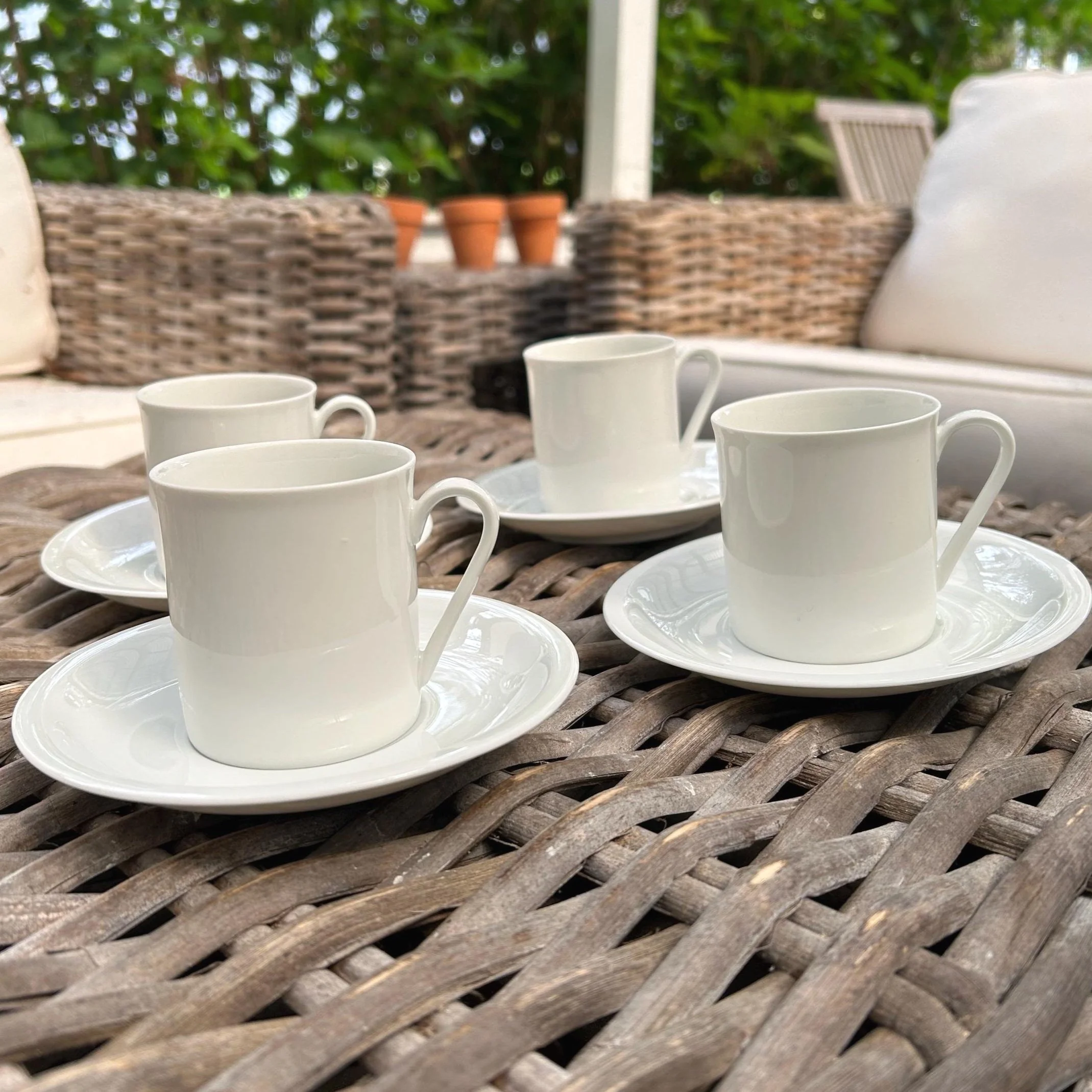 Set of 4 vintage Arzberg porcelain cup and saucer duos. Classic white glaze, made in Germany. Elegant, versatile, and collectible.