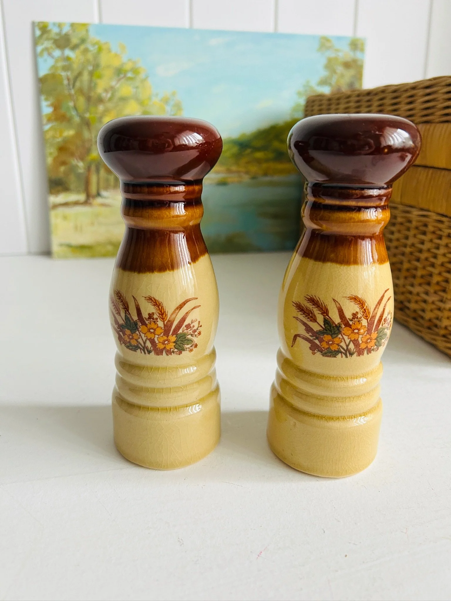 Front view of vintage ceramic salt and pepper shakers with tri-tone glaze and wheat floral motif