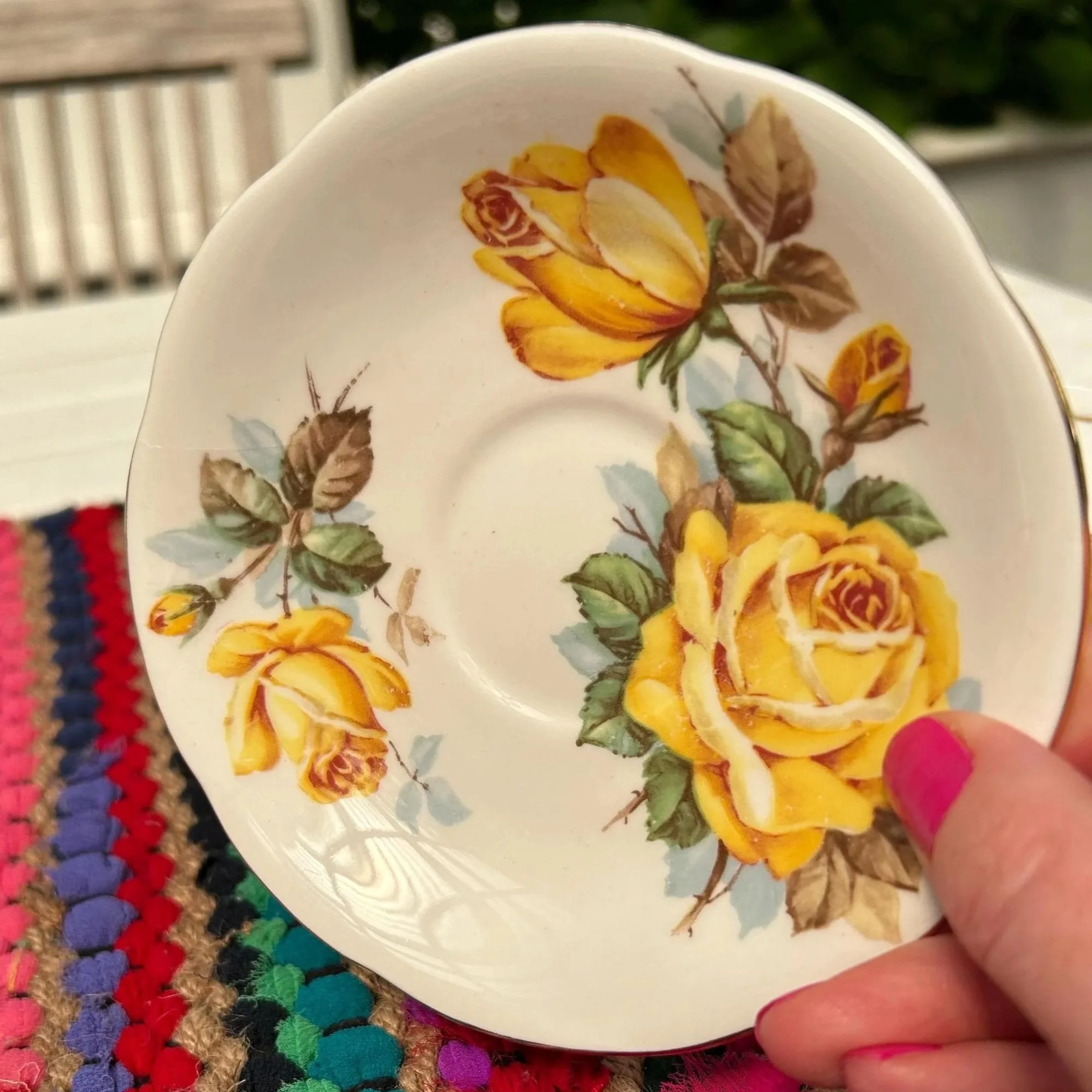 Overhead of saucer featuring yellow rose motif
