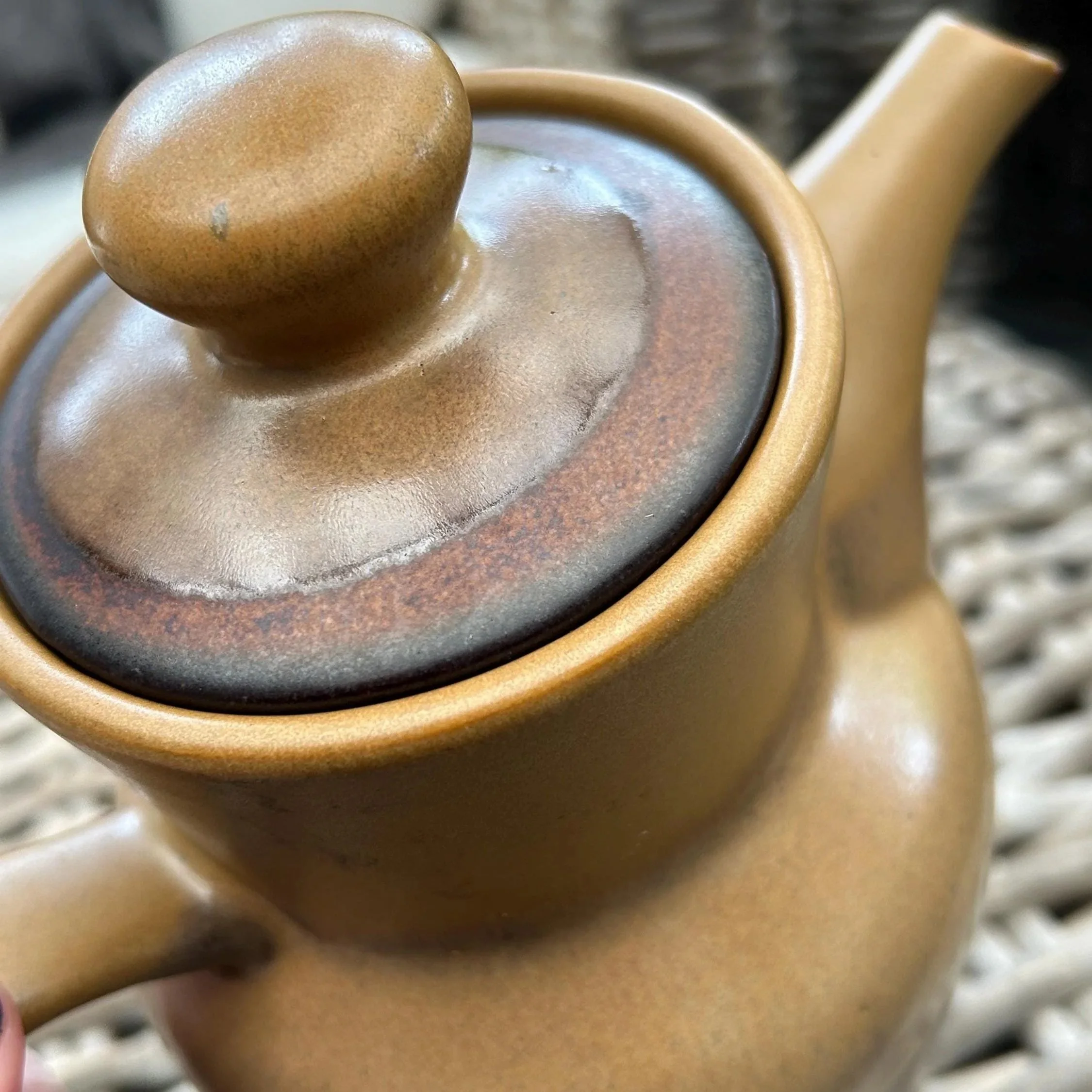 Close-up of lid with soft speckled brown glaze and knob top
