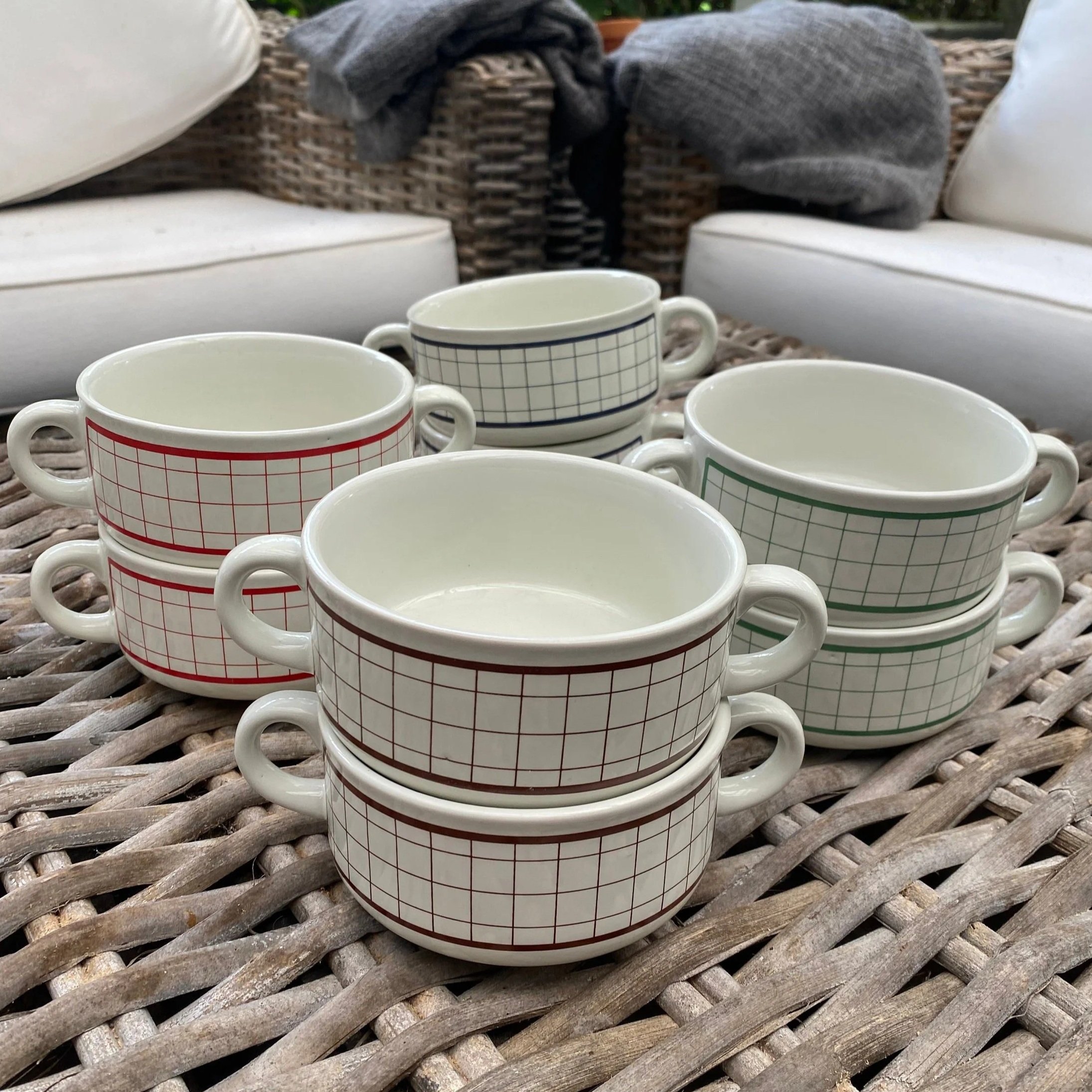 Assorted grid pattern ceramic soup mugs with twin handles displayed together