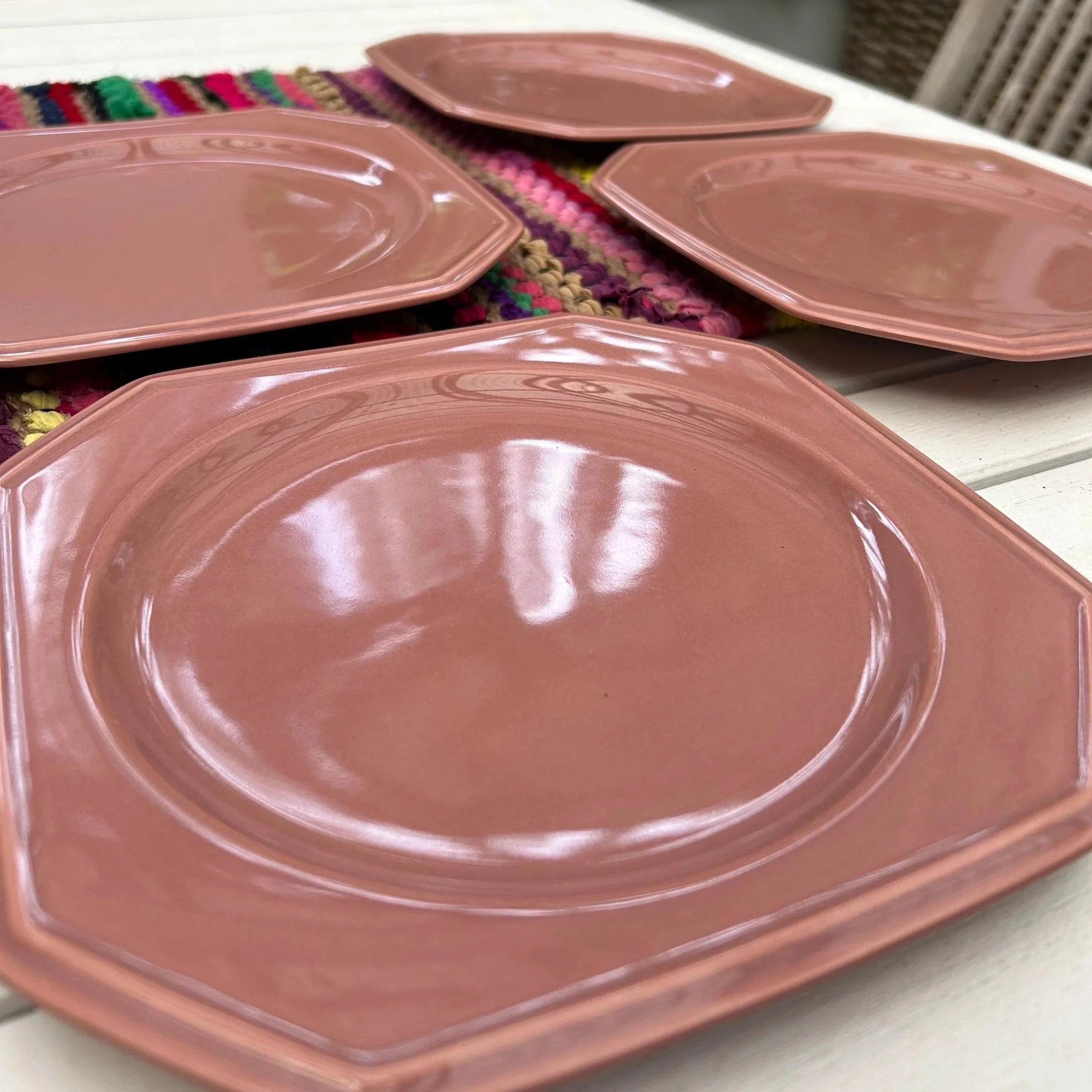 Overhead view of all four Mikasa Rose Gray side plates on display