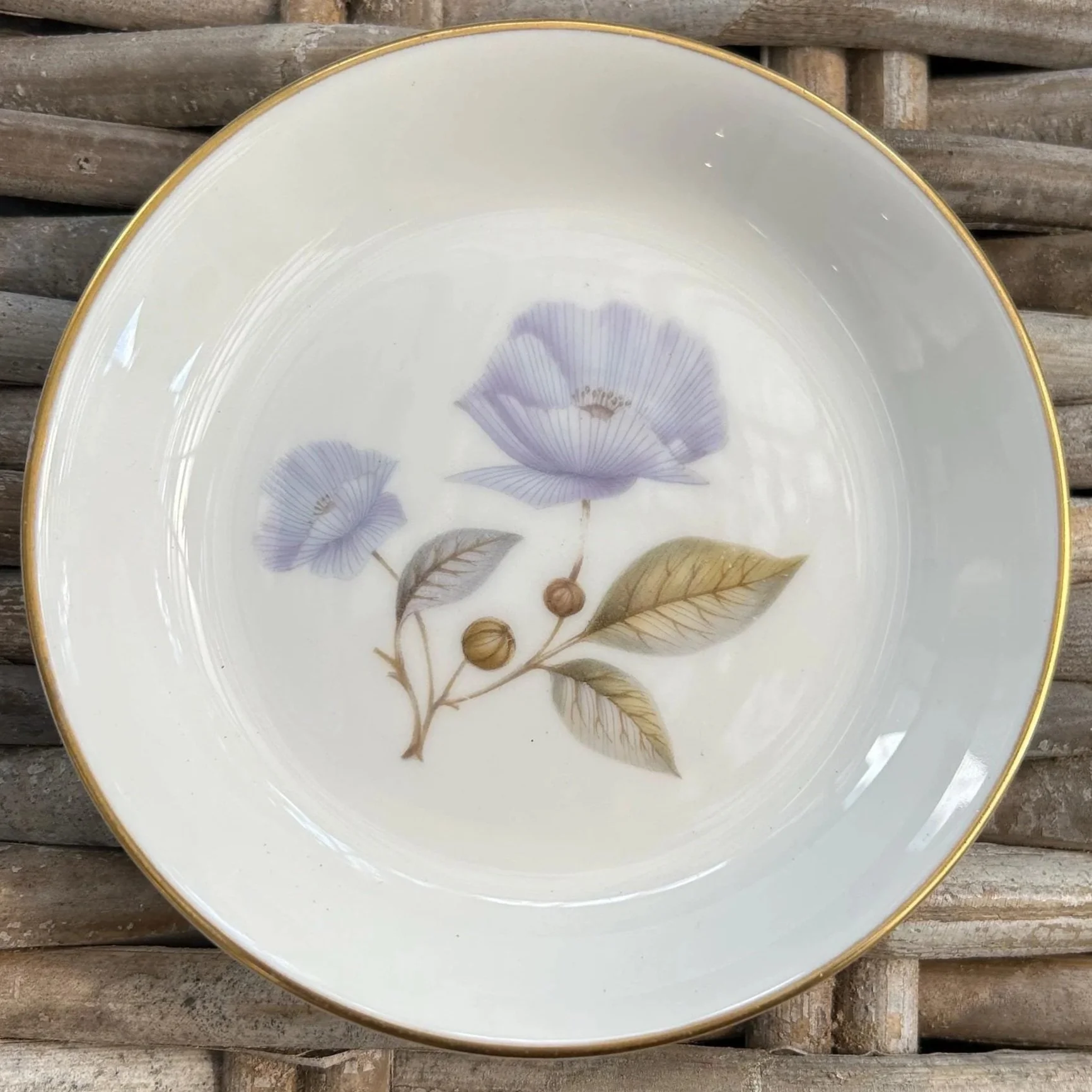 Close-up of larger purple flower dish with gold trim