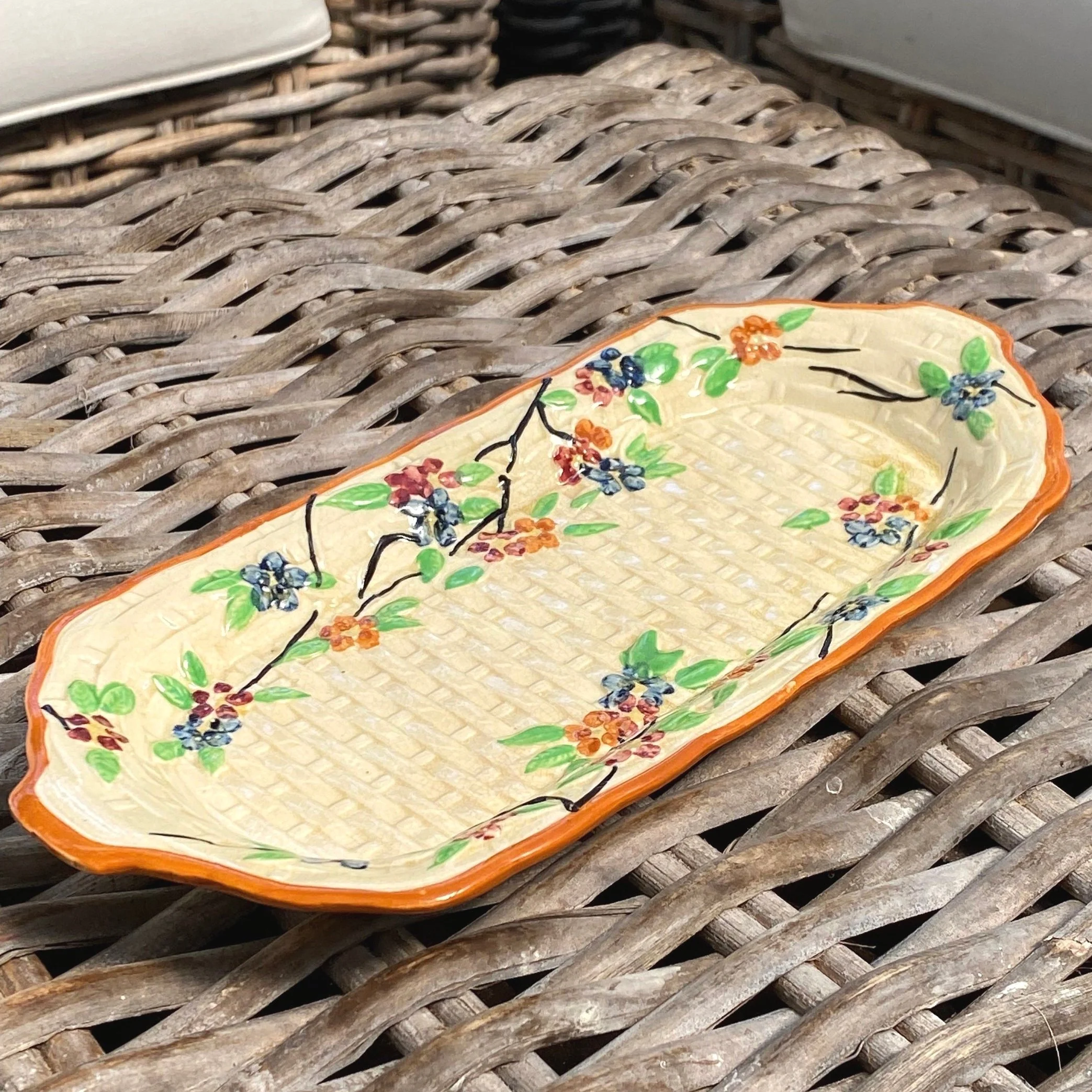 Rectangular ceramic tray with basketweave texture and floral design. Hand-painted, made in Japan. Ideal for sandwiches or as decorative serveware.
