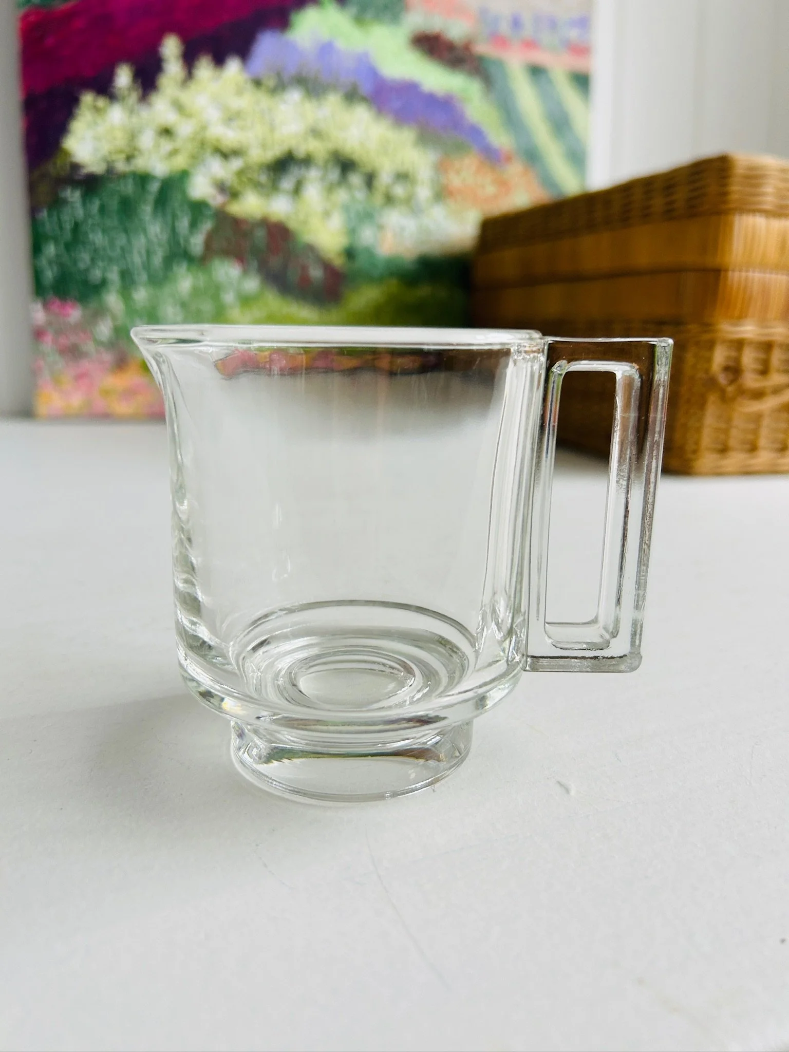 Full side view of the Arno pressed glass creamer on a white surface, showing its clean mid-century silhouette and pedestal base