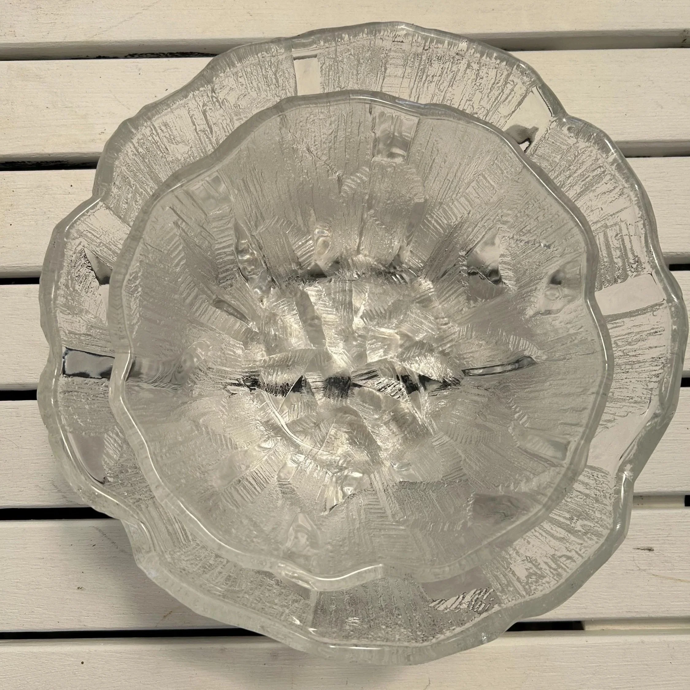 Top-down view of large bowl on white slats – highlighting scalloped rim and detailed interior texture