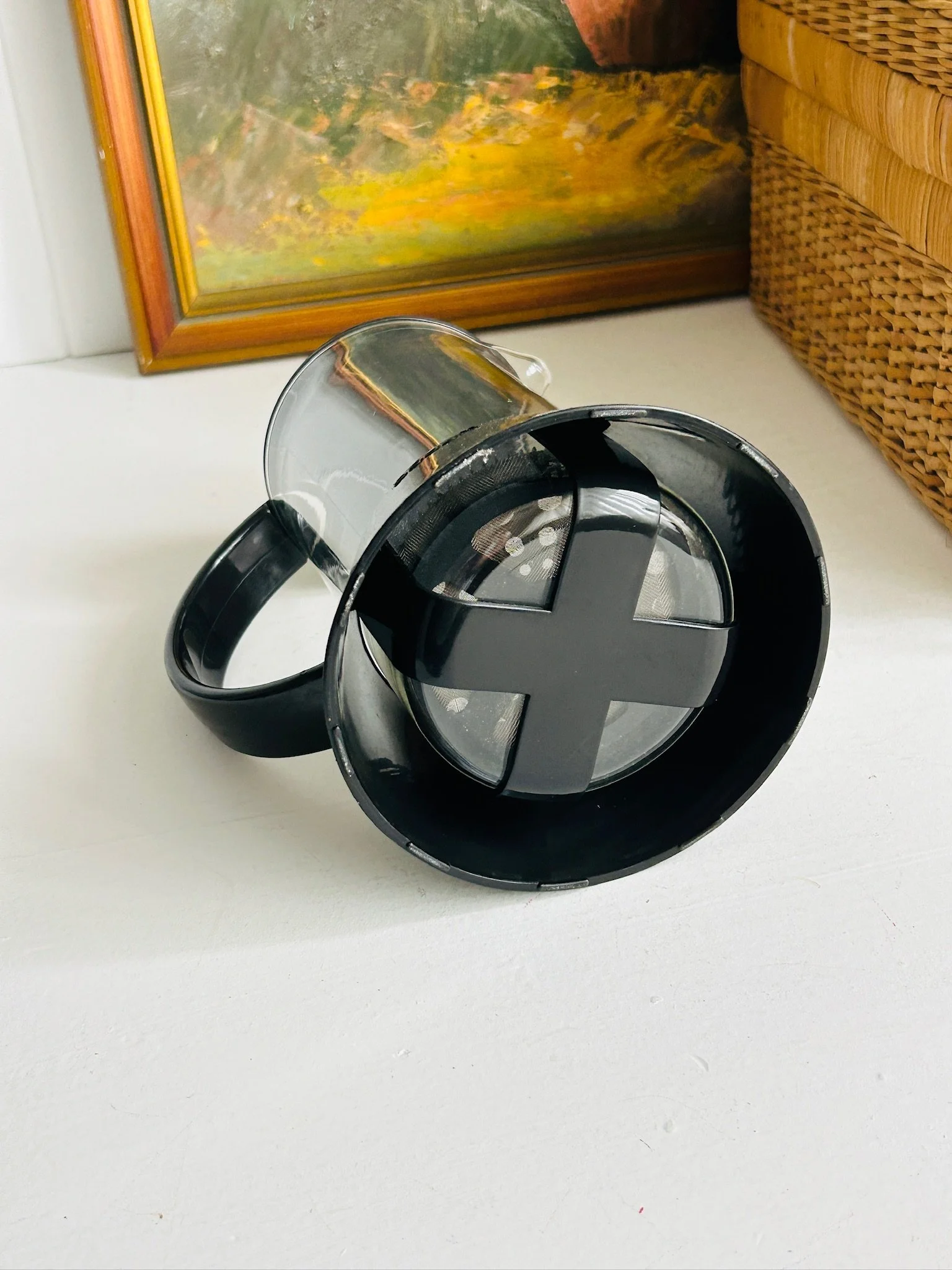 Overhead view into the French press with the lid removed, showing the circular opening, black frame, and glass carafe interior.