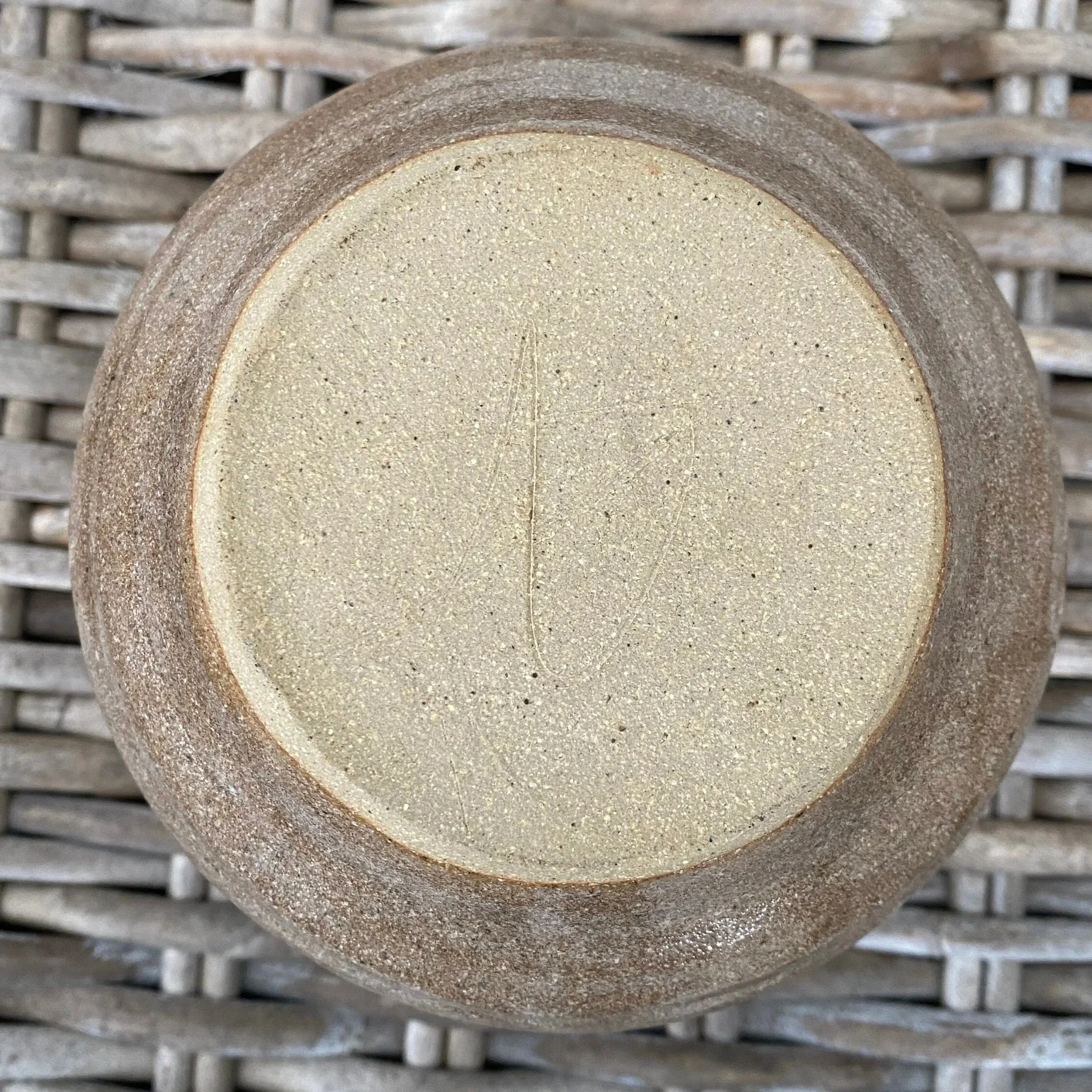 Underside of vase showing unglazed base and wheel-thrown finish