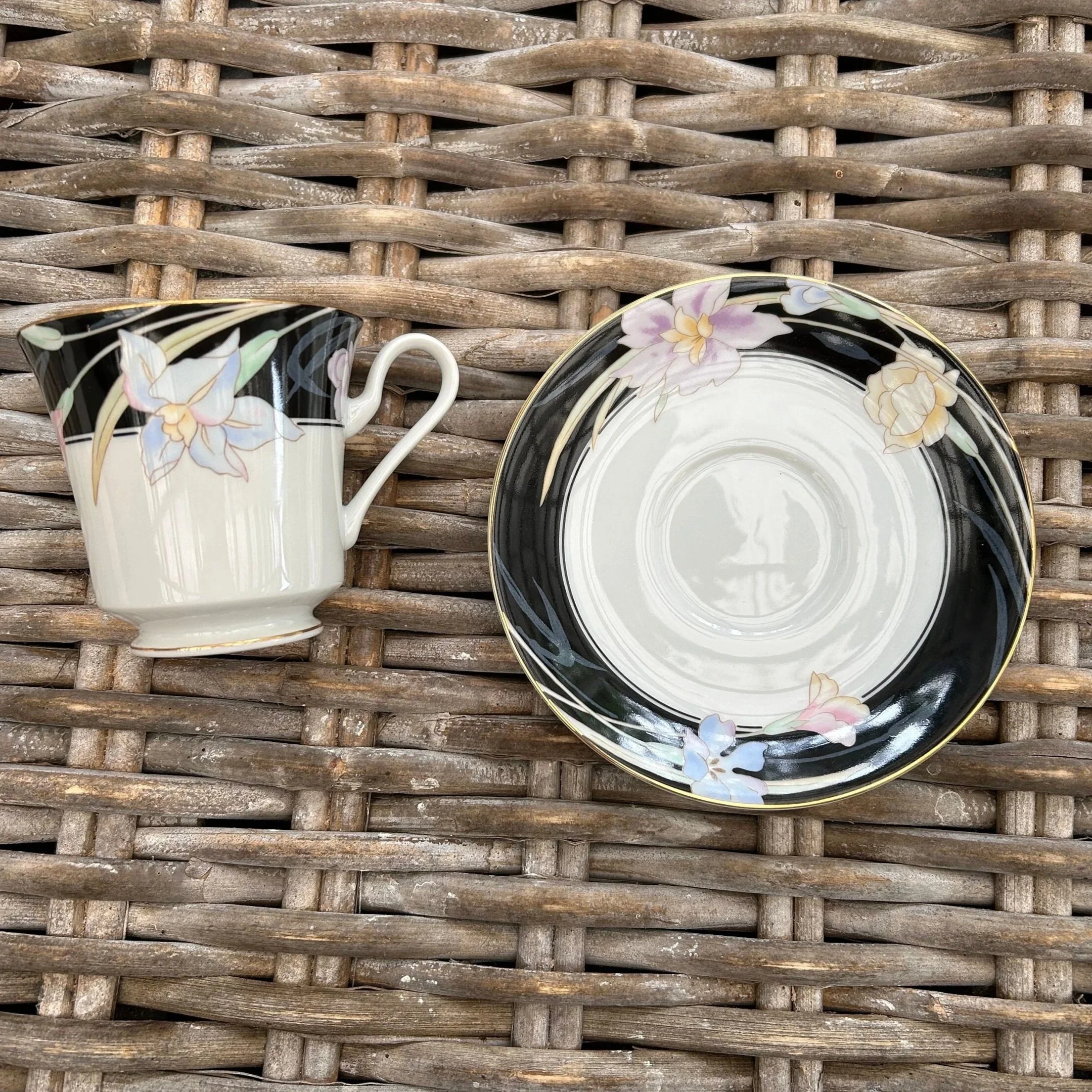 Side-by-side of cup and saucer showing floral design and form