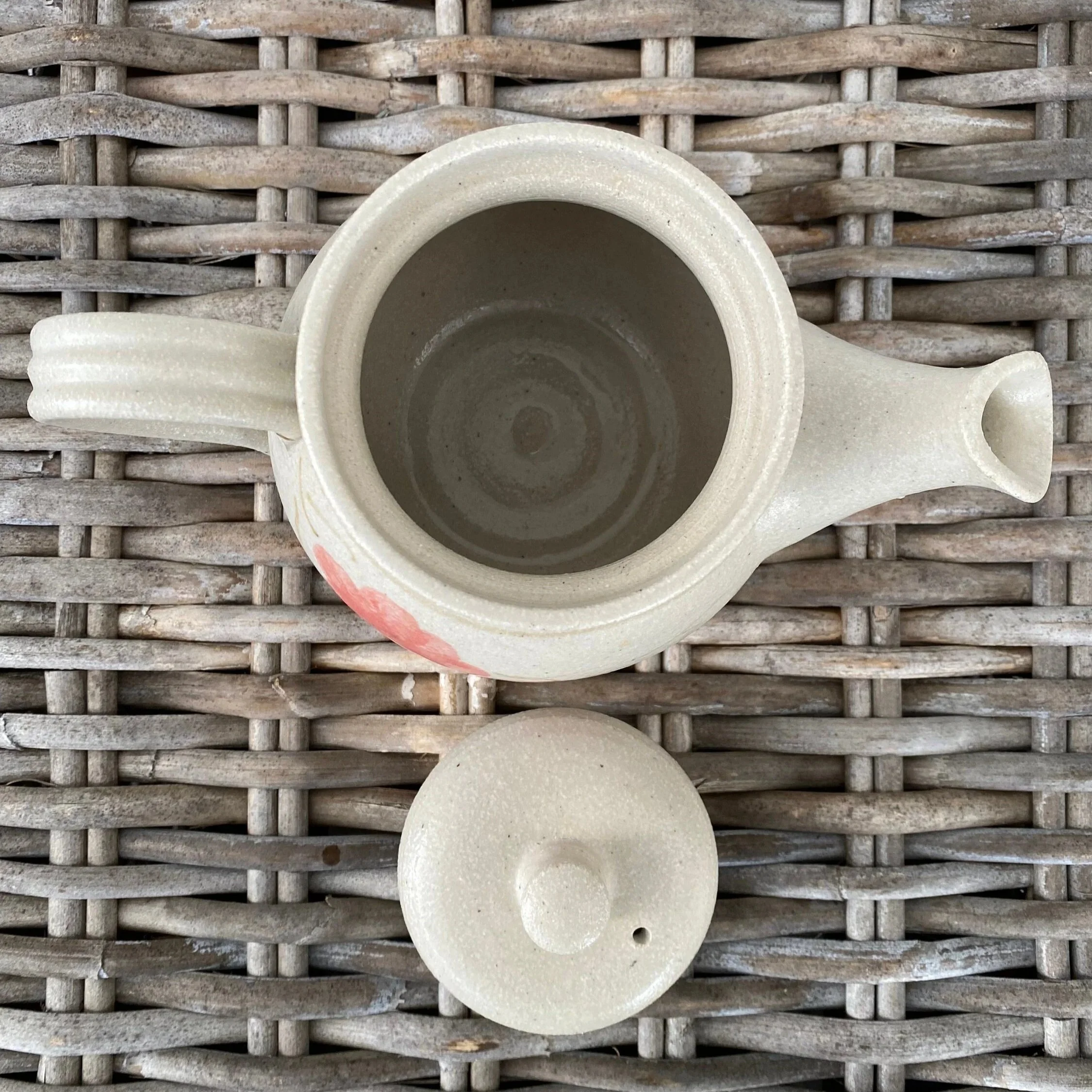 Top-down view of teapot with lid removed and interior visible