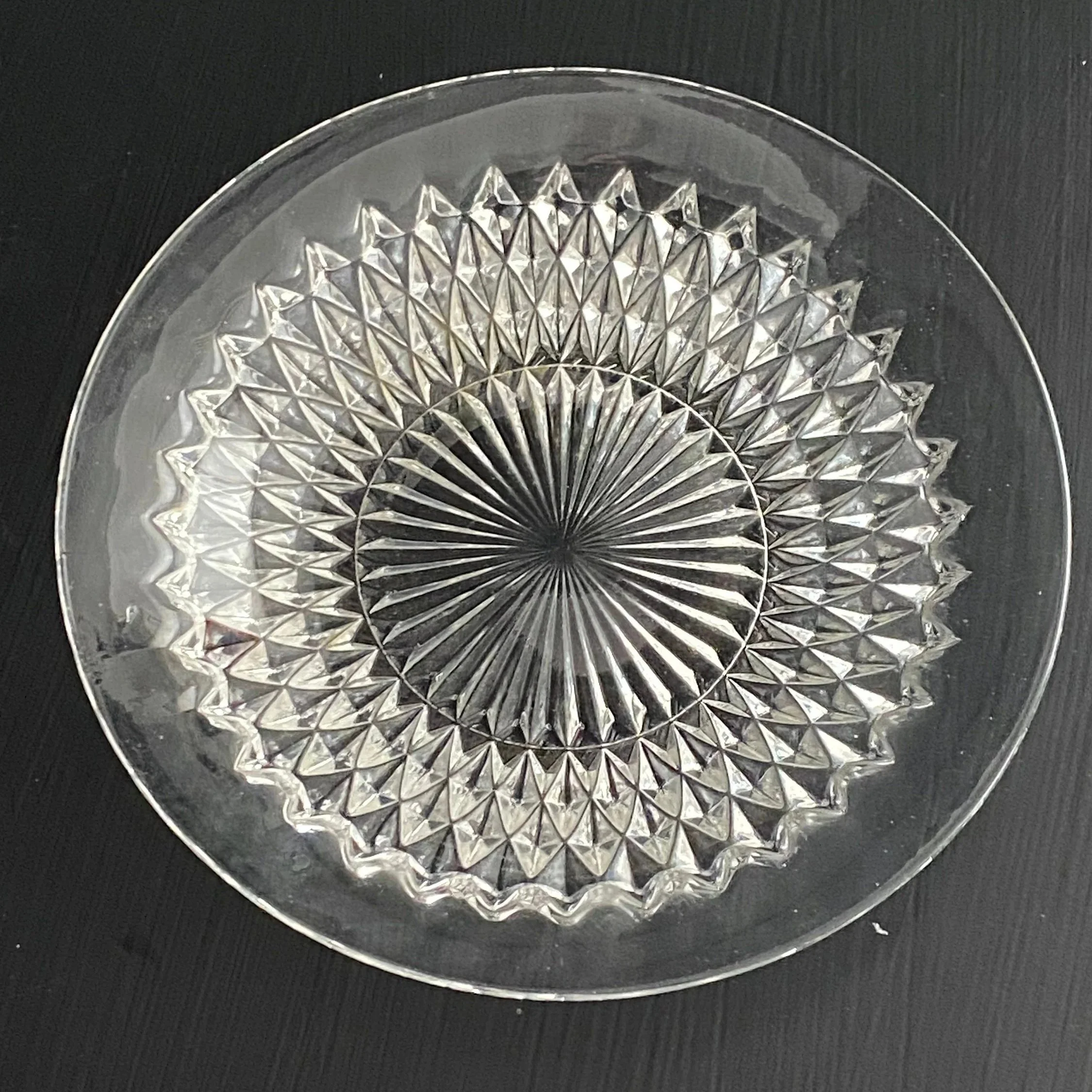 Full view of vintage glass platter with diamond cut pattern and sunburst centre