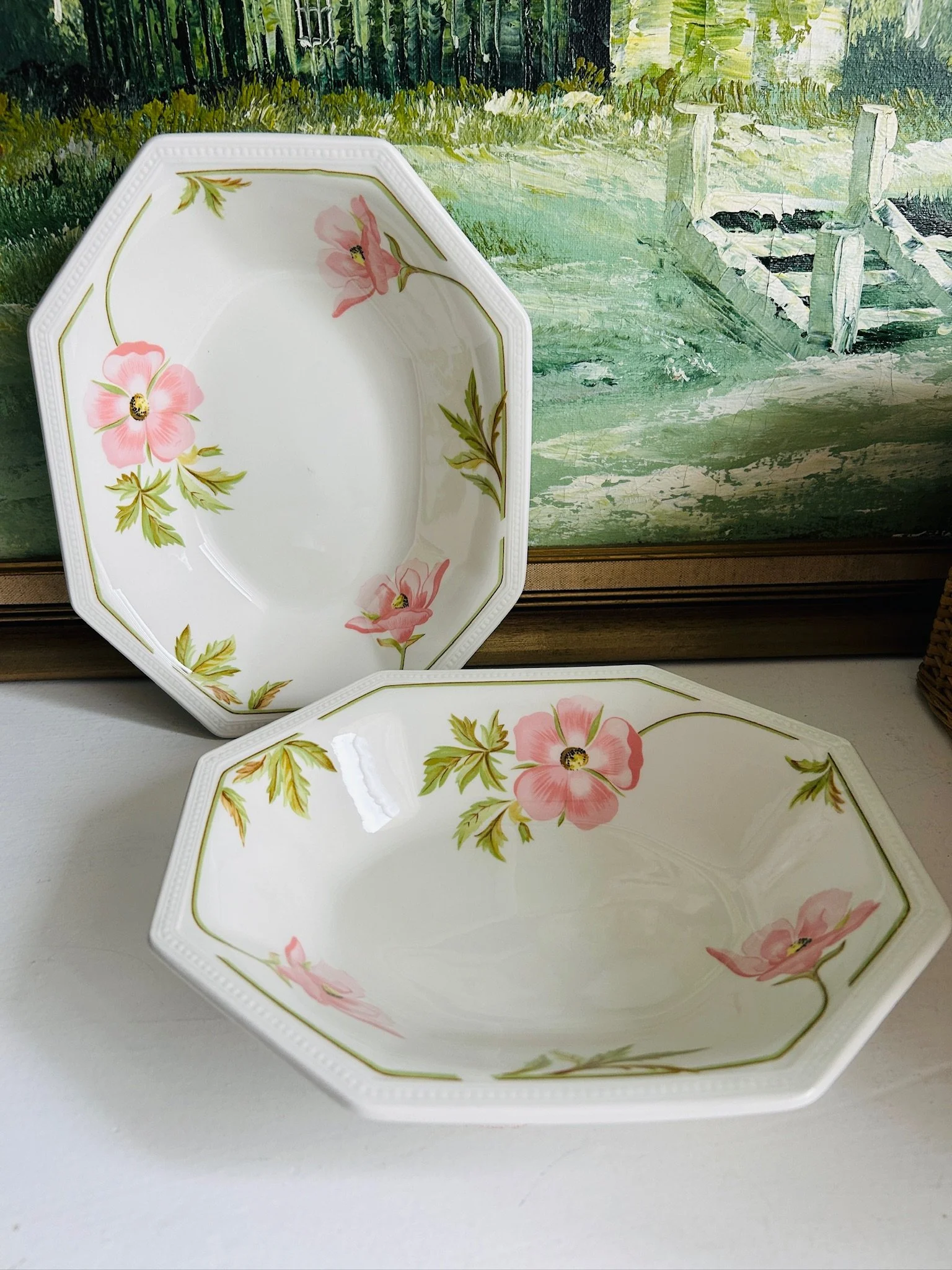 Pair of vintage floral bowls displayed together upright, showing both bowls from the front with matching pink and green patterning.