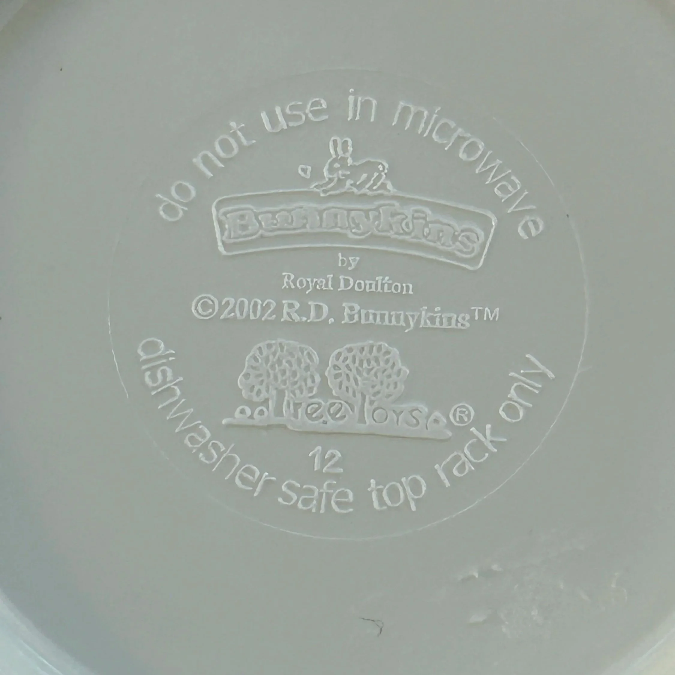 Base interior marking on Royal Doulton Bunnykins melamine bowl showing 2002 date, care instructions, and Bunnykins branding