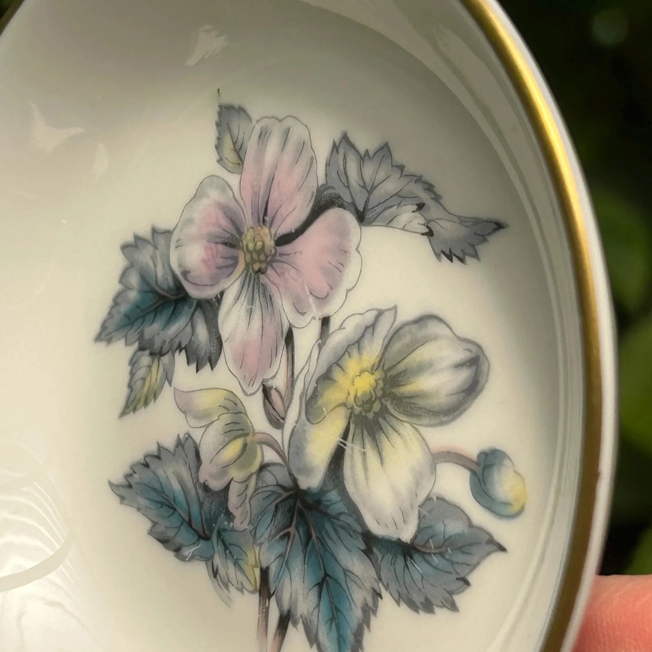 Close-up of central floral motif – pastel blooms and soft leaves