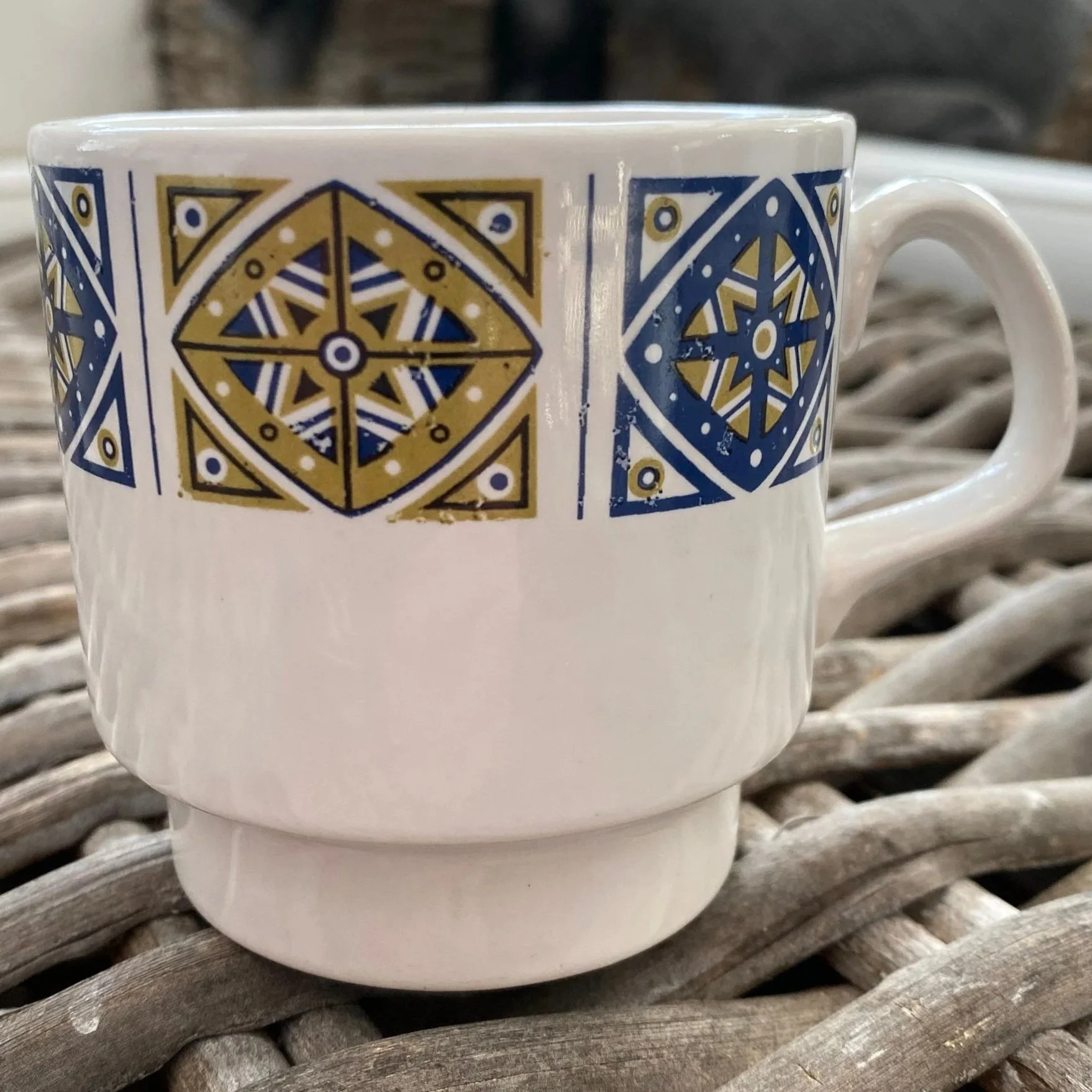 Close-up of front of one mug showing fine detail in pattern