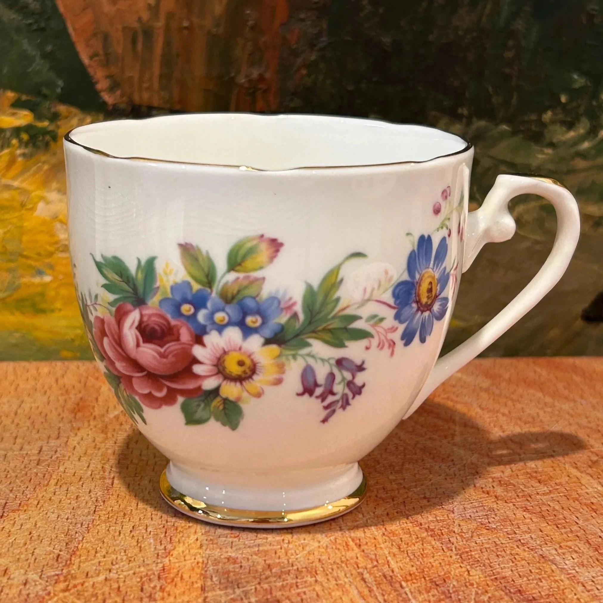 Side view of the teacup showing detailed floral transfer and handle shape