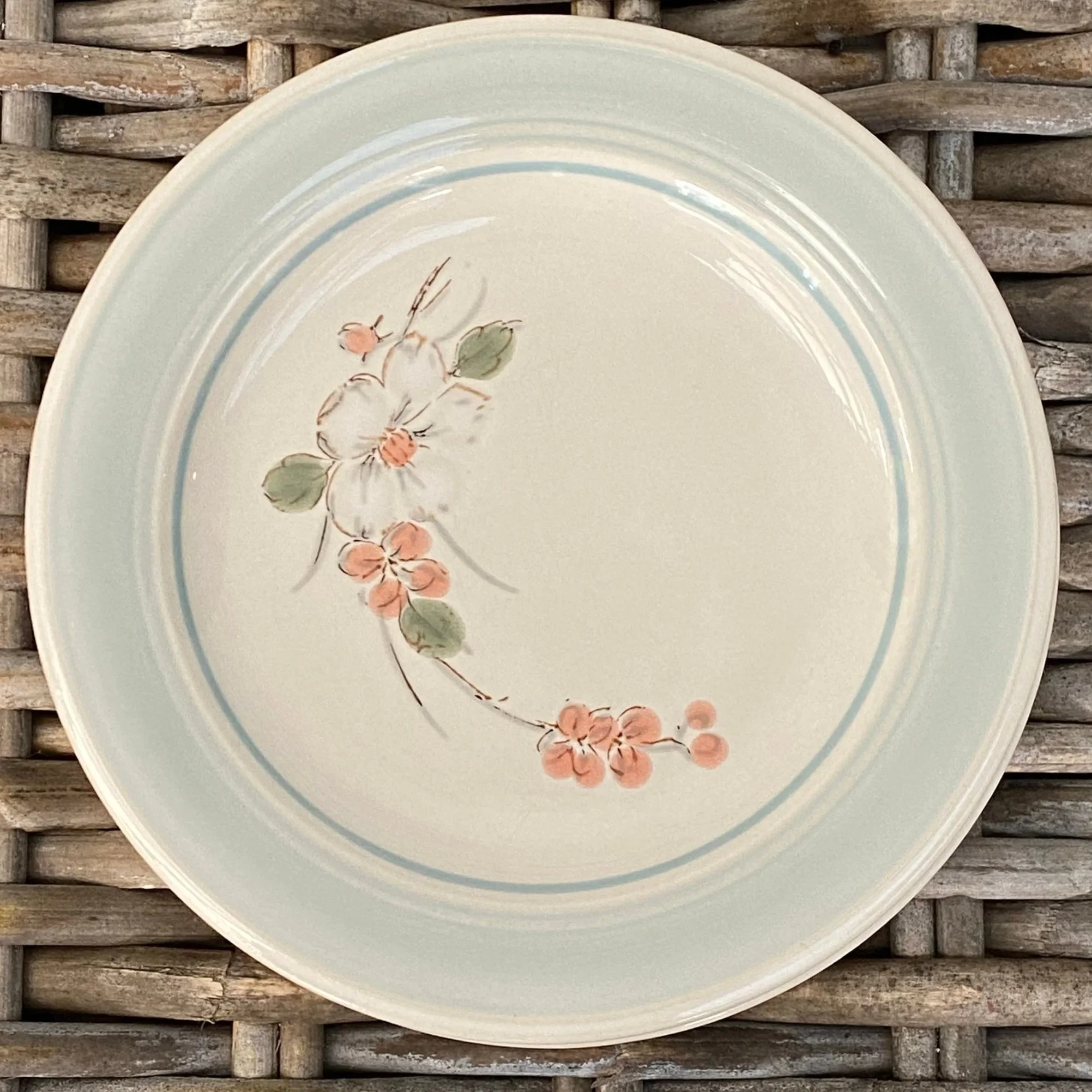 Single plate close-up showing floral detail and blue band