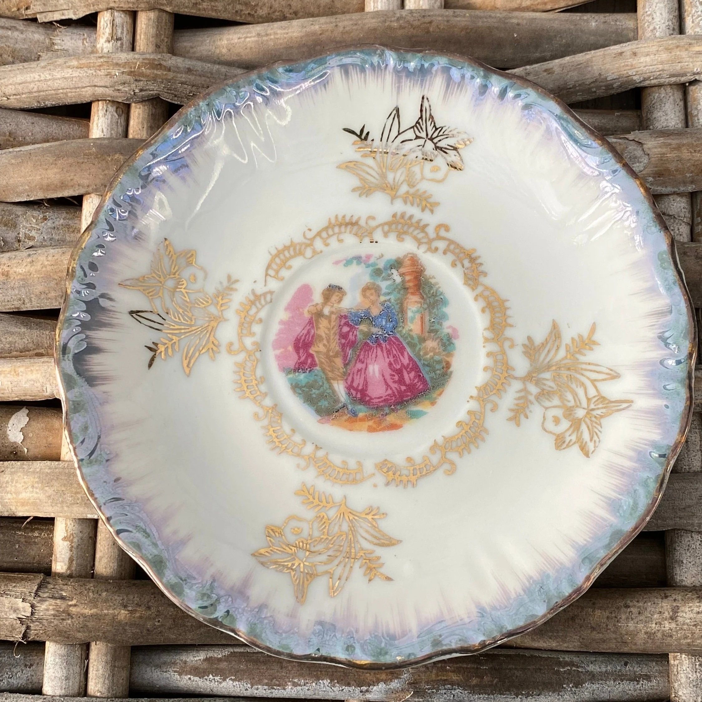 Saucer detail with matching romantic scene and lustre glaze