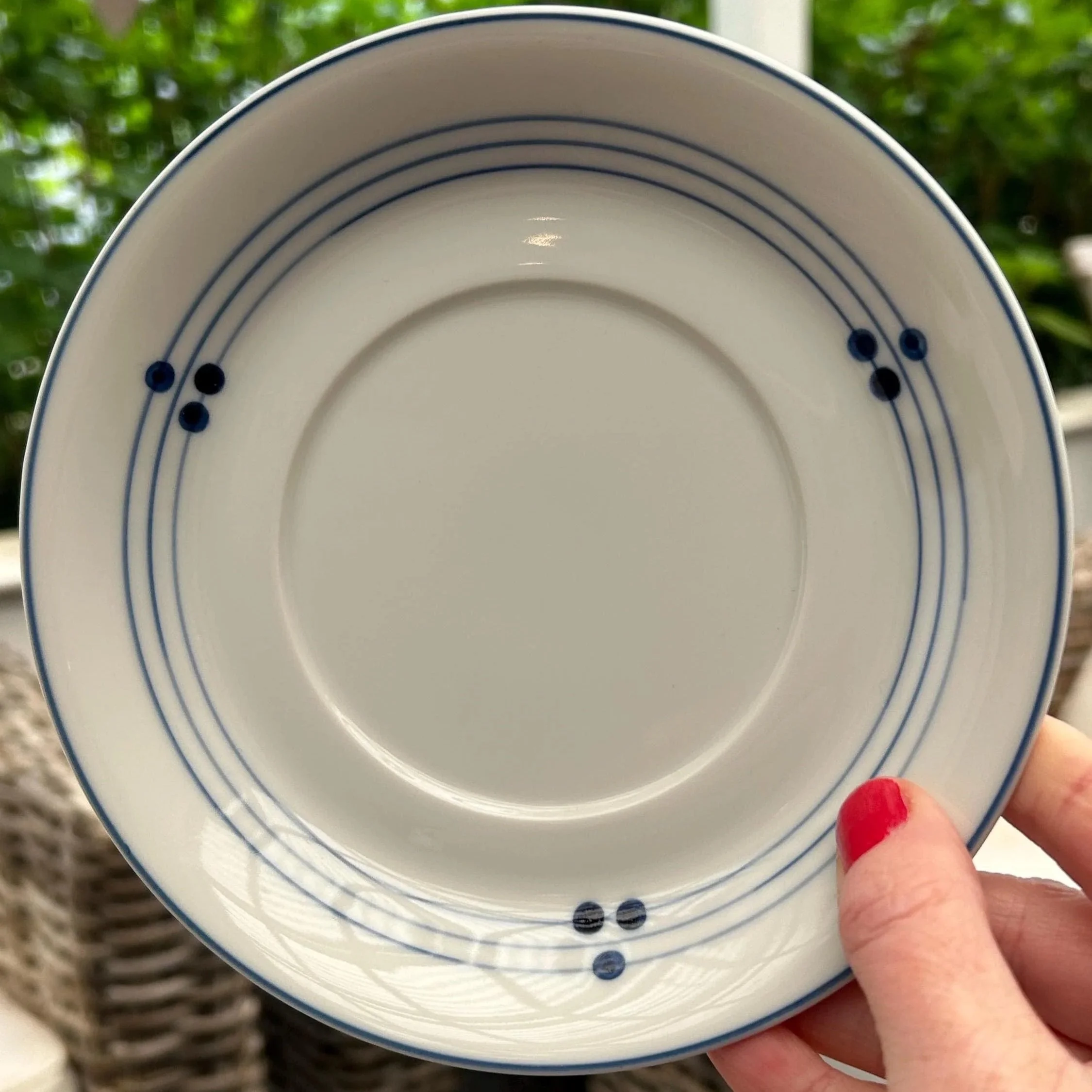 Close-up of saucer – highlighting triple-dot design and blue rings