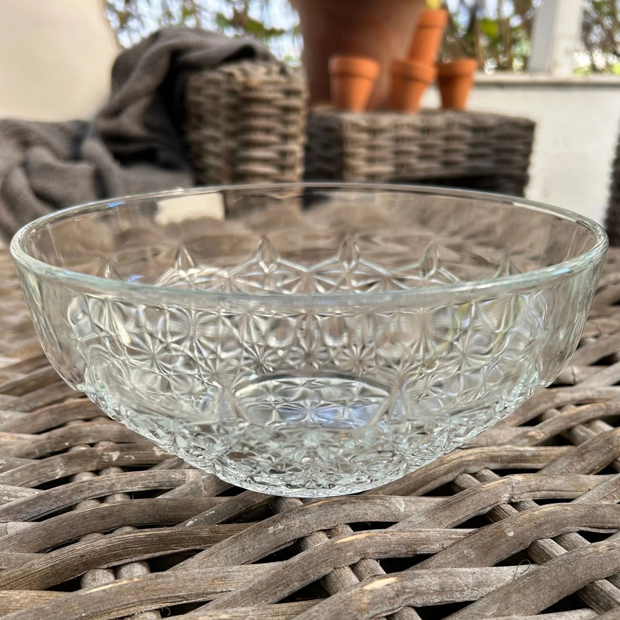 Luxhem Veropa clear glass bowl on rattan table, showing intricate geometric pattern