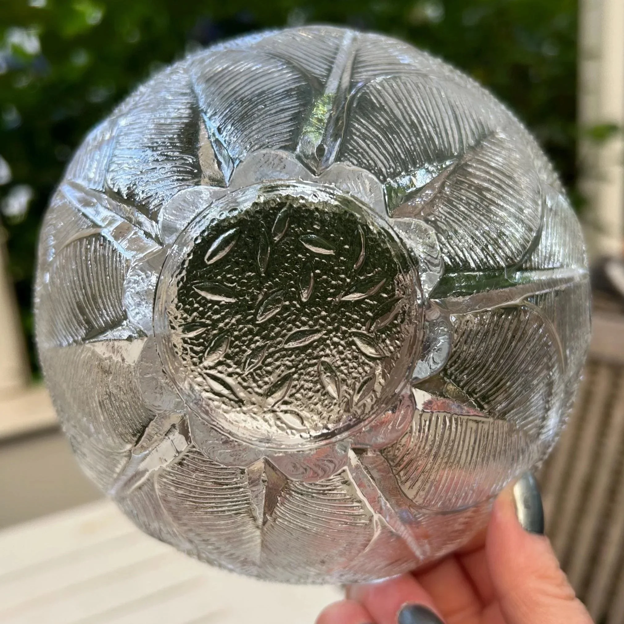 Base view of a single bowl showing the starburst-style pressed pattern underneath