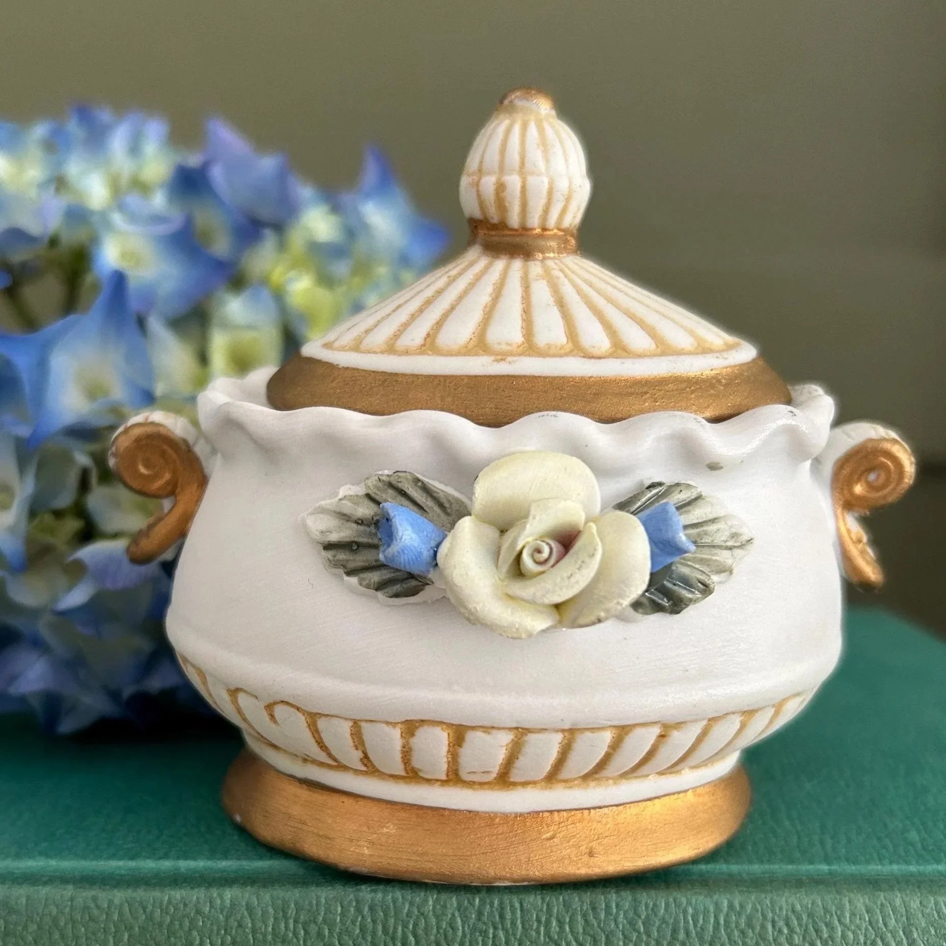 Vintage biscuit porcelain trinket box from Italy with floral appliqué and gold accents. Handmade by Creazione Artigiana di Monte. Elegant & collectible.
