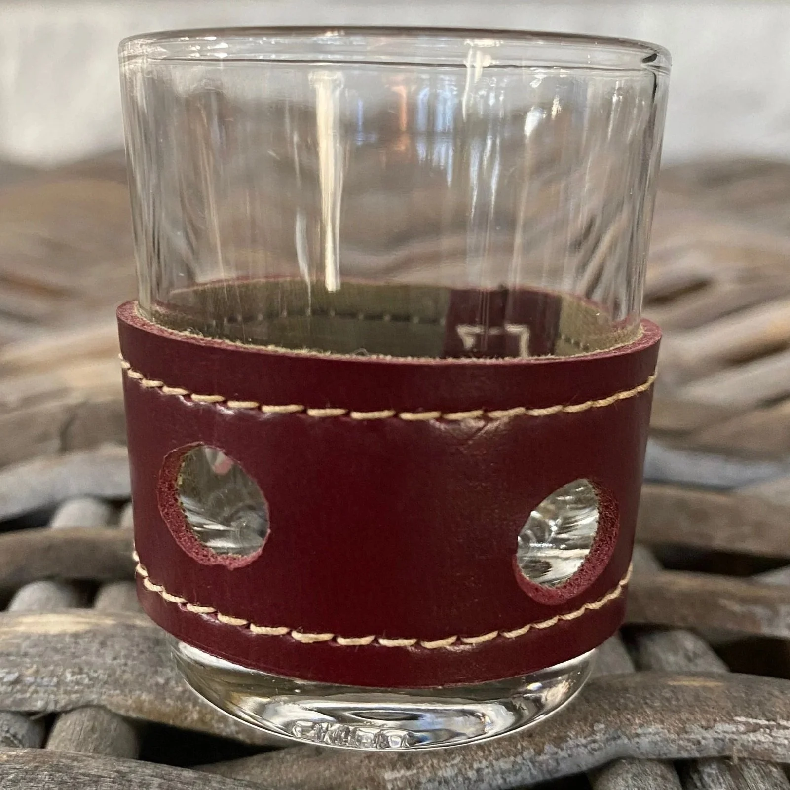 Burgundy leather wrap with stitched trim and two circular cut-outs