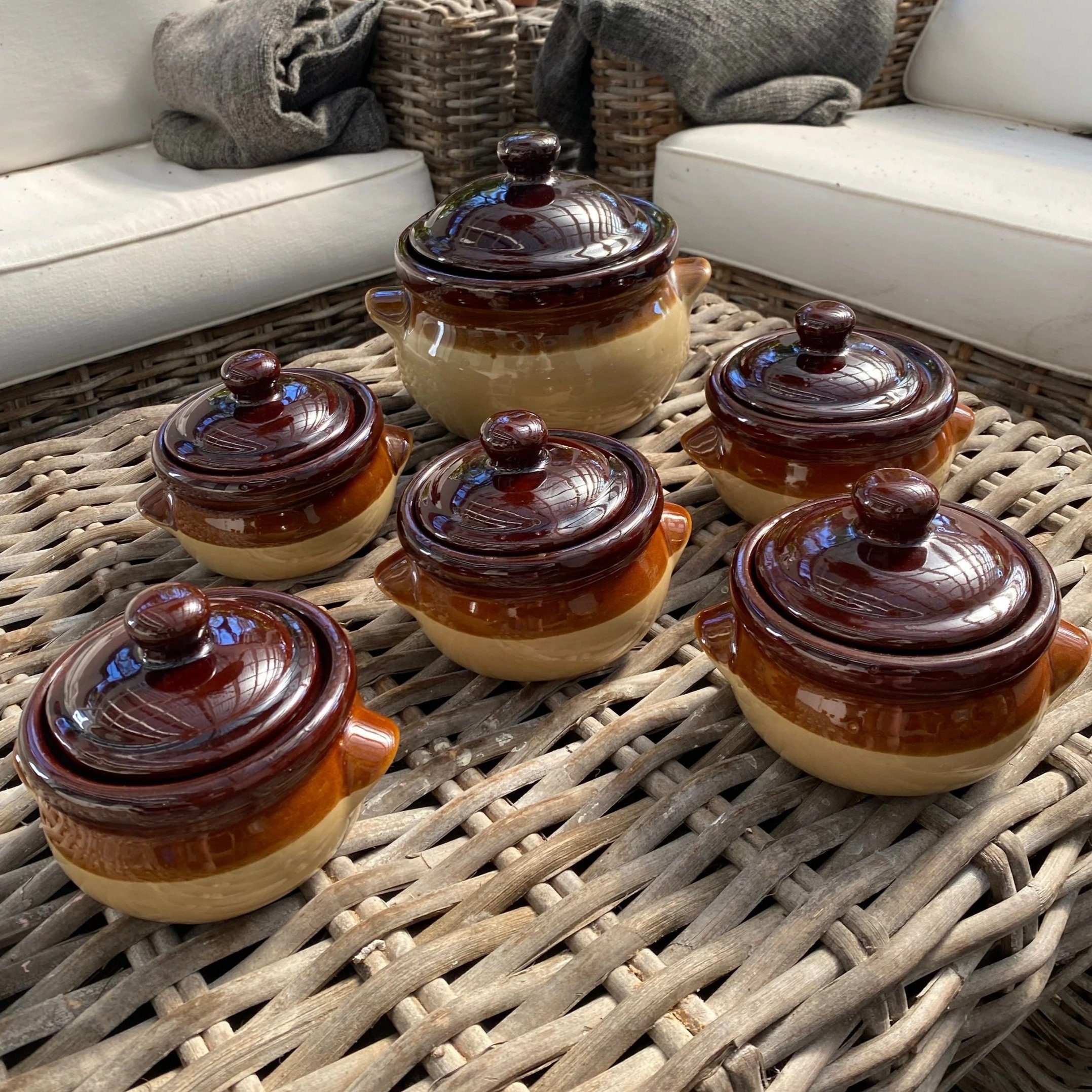 Full set of 6 vintage brown glazed stoneware pots on wicker table