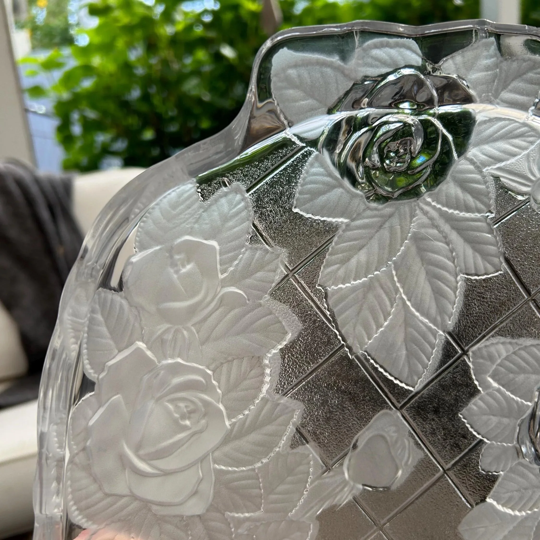 Close-up of top handle area – etched rose and leaf detail visible