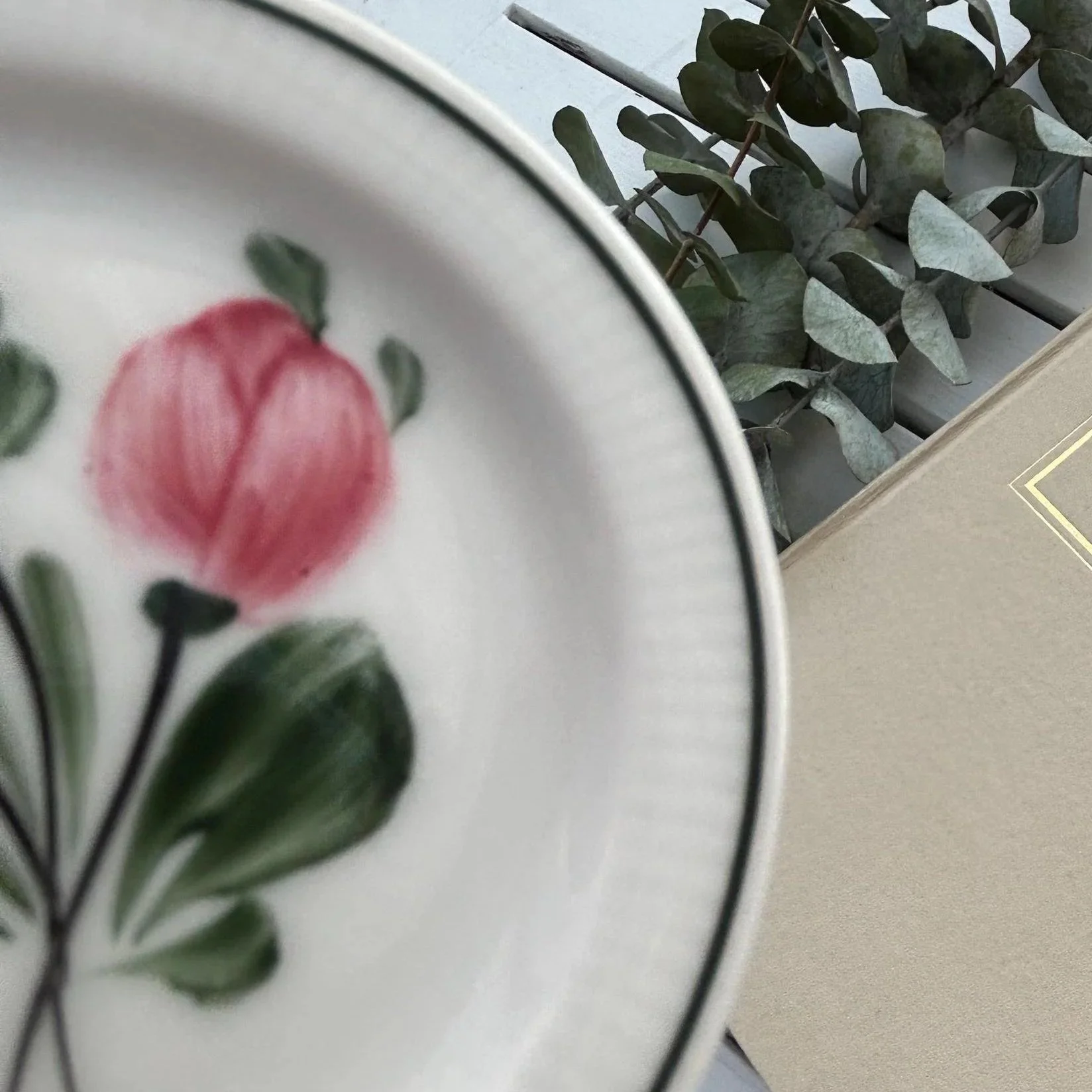 Close-up of hand-painted floral detail and ribbed porcelain texture