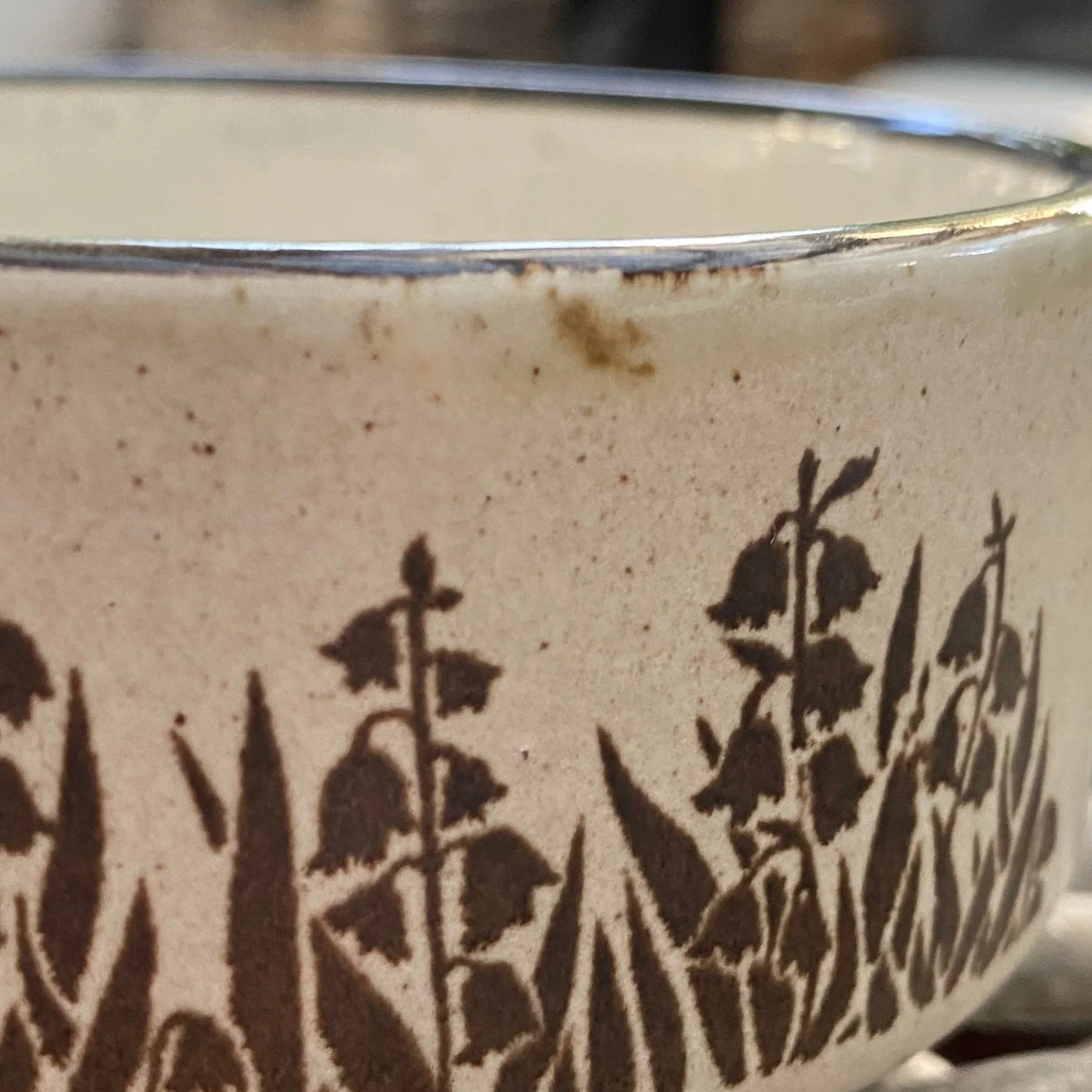 Close-up of speckled glaze texture and brown rim