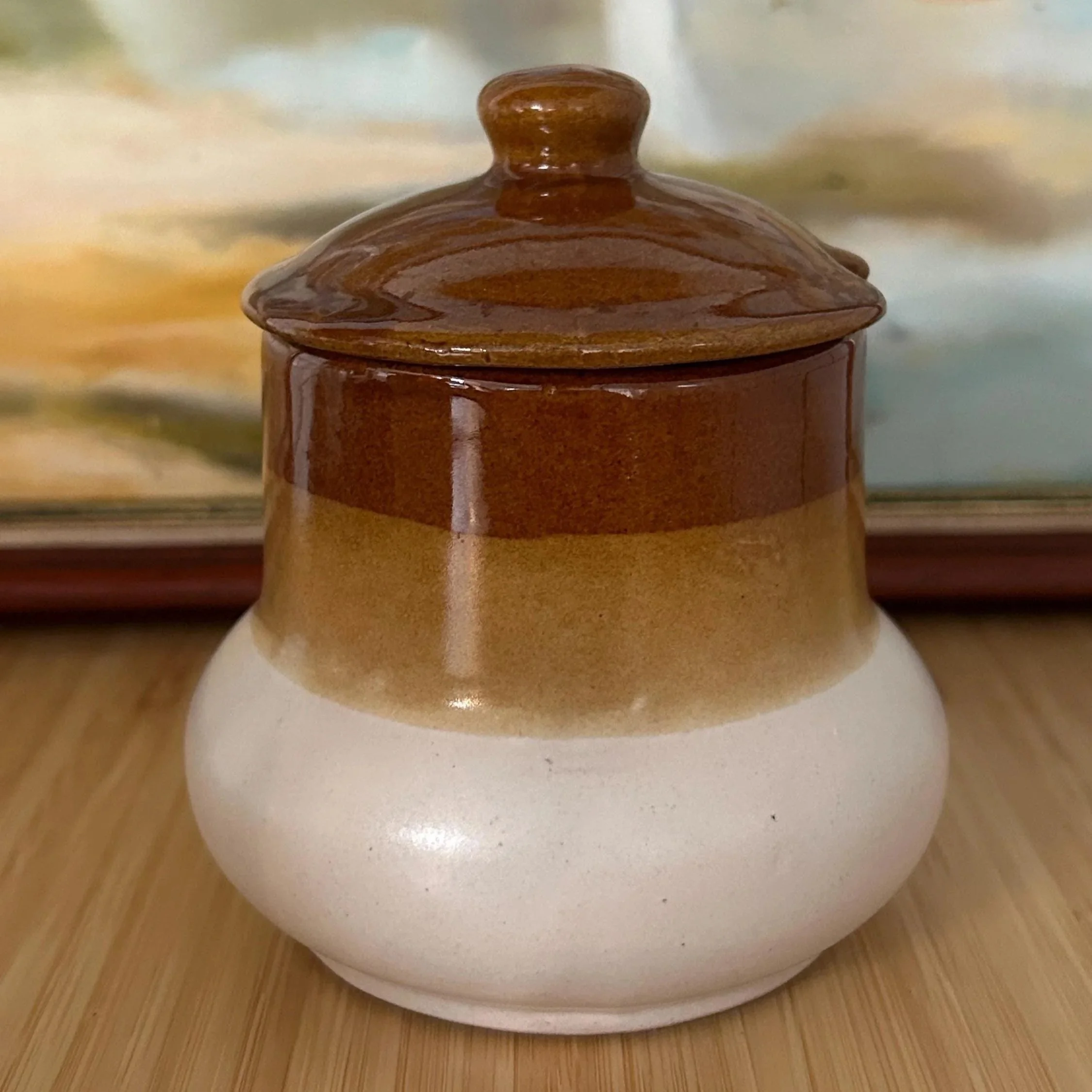 Sugar bowl with lid, showing caramel and cream speckled tones