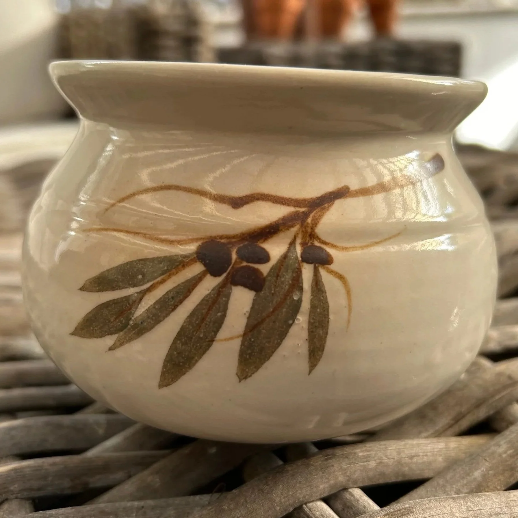 Front view of vintage pottery sugar bowl with hand-painted gumnut design