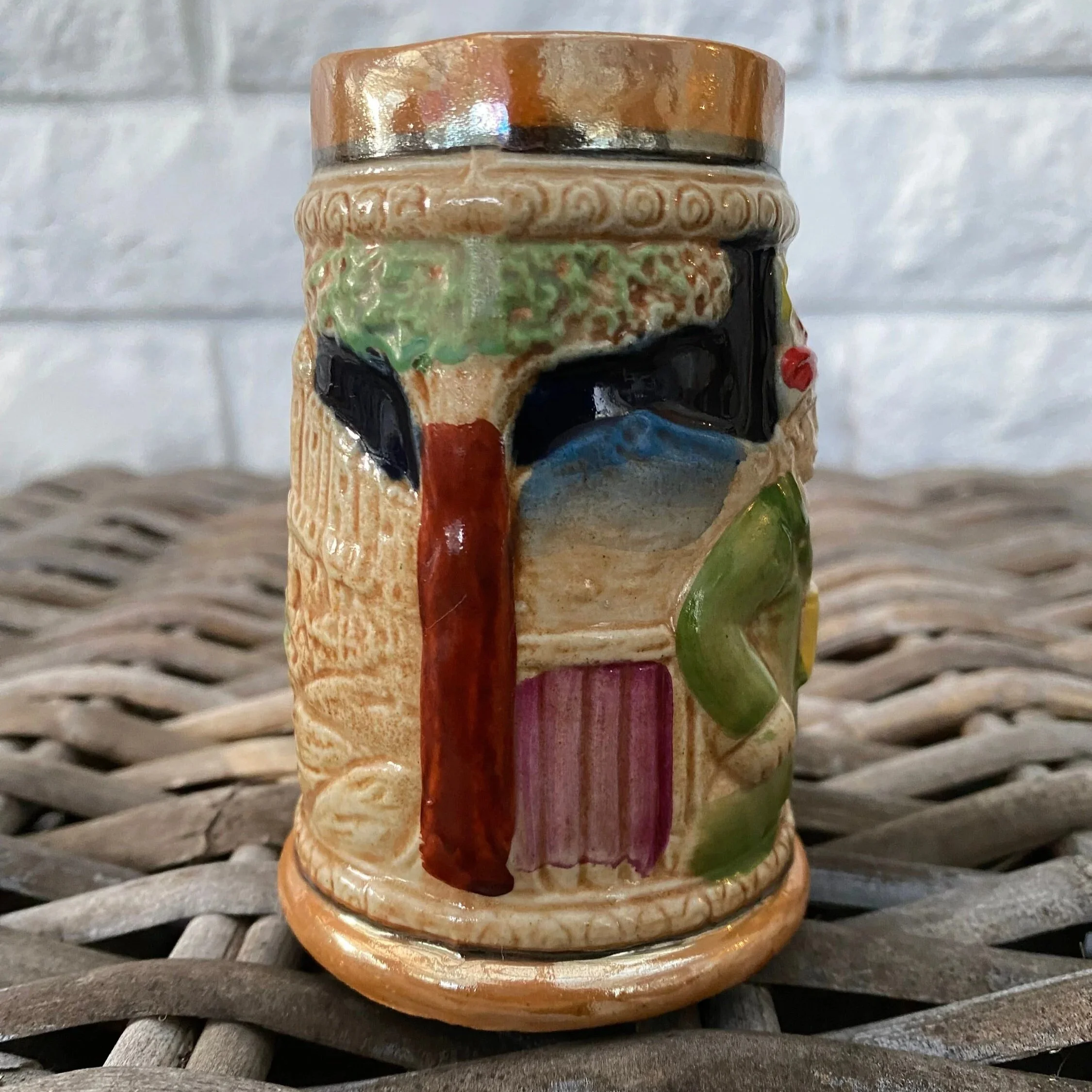 Back view of tankard showing town buildings in relief.