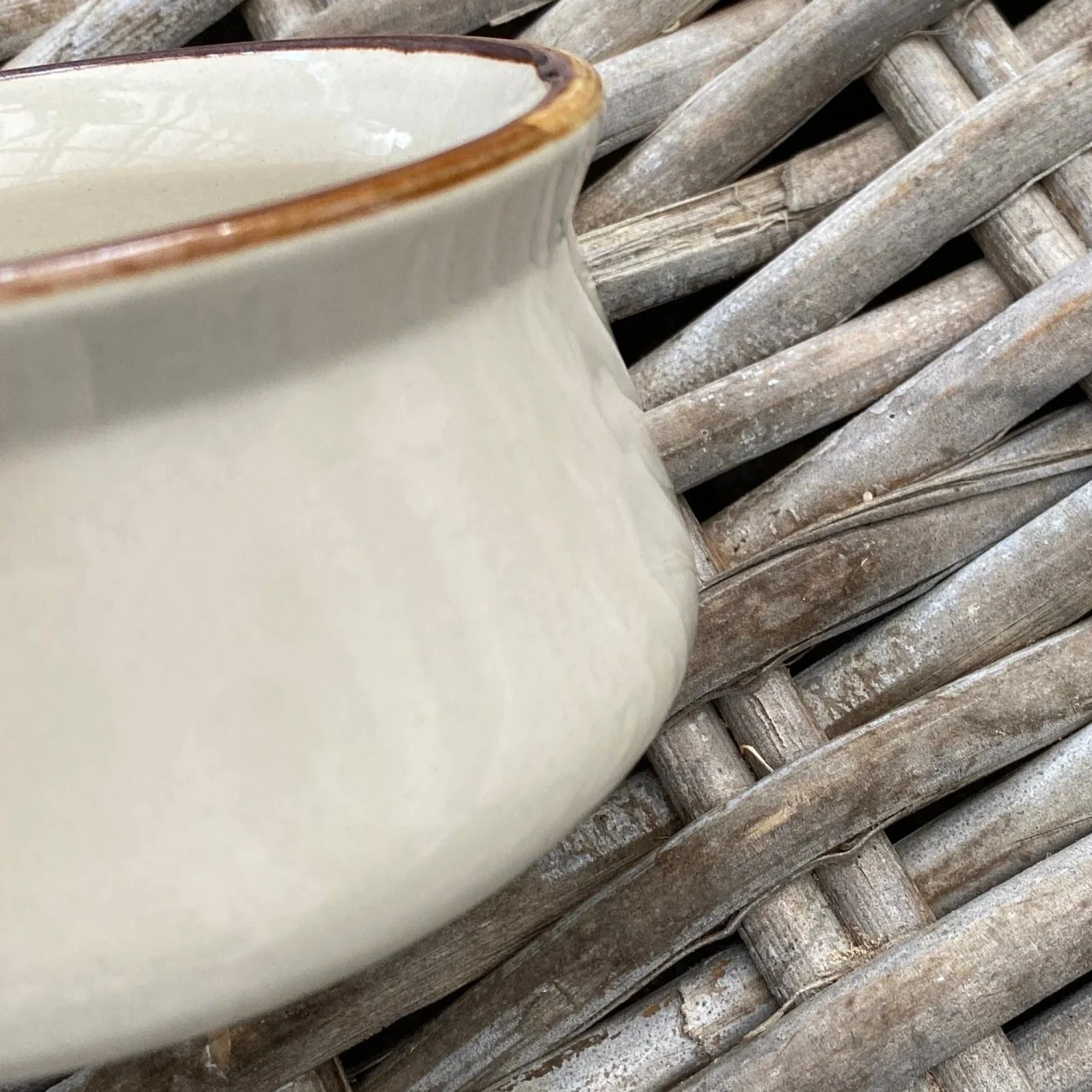 Side profile of mid-century ceramic bowl showing flared shape and rim detail