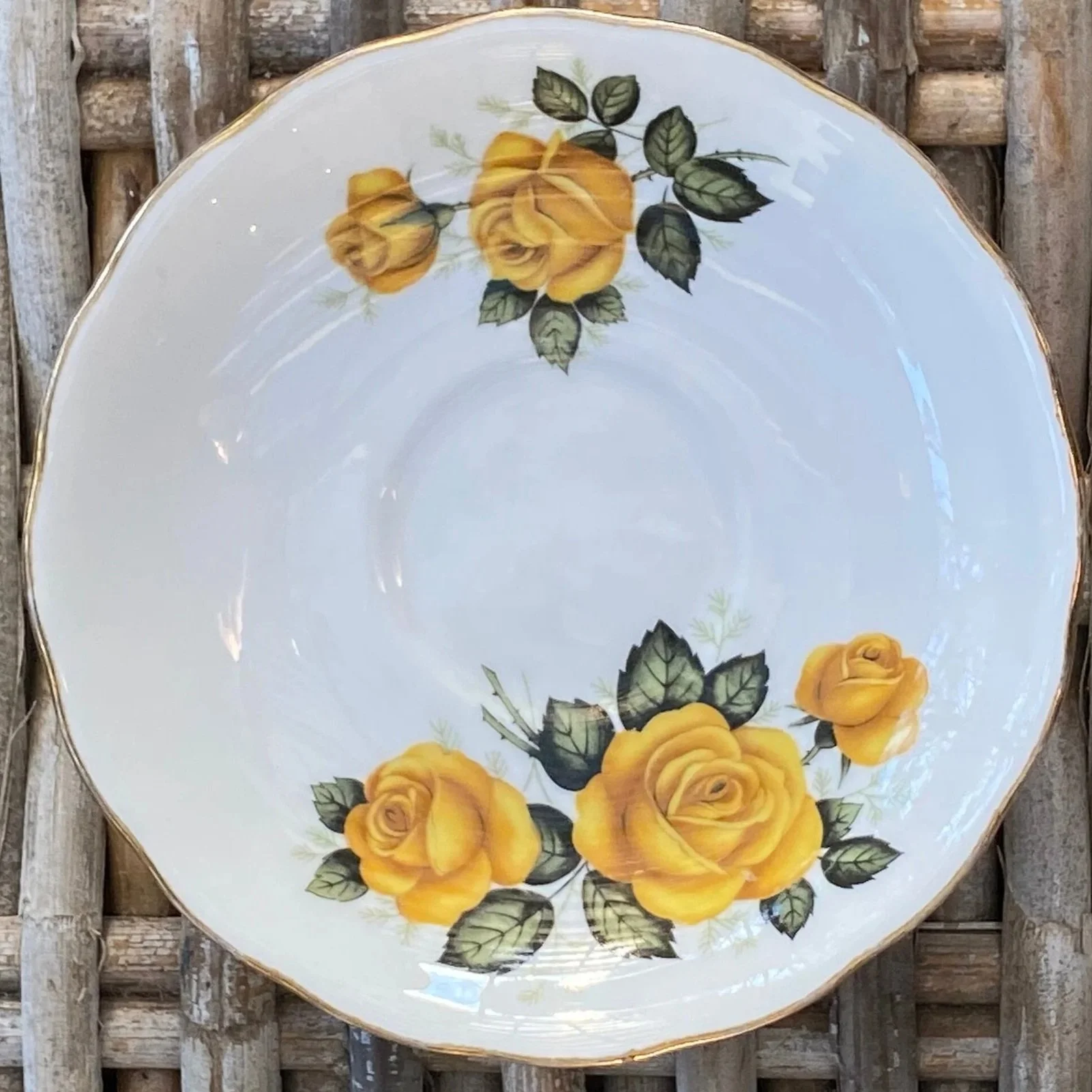 Top-down view of saucer highlighting full floral pattern and rim detail